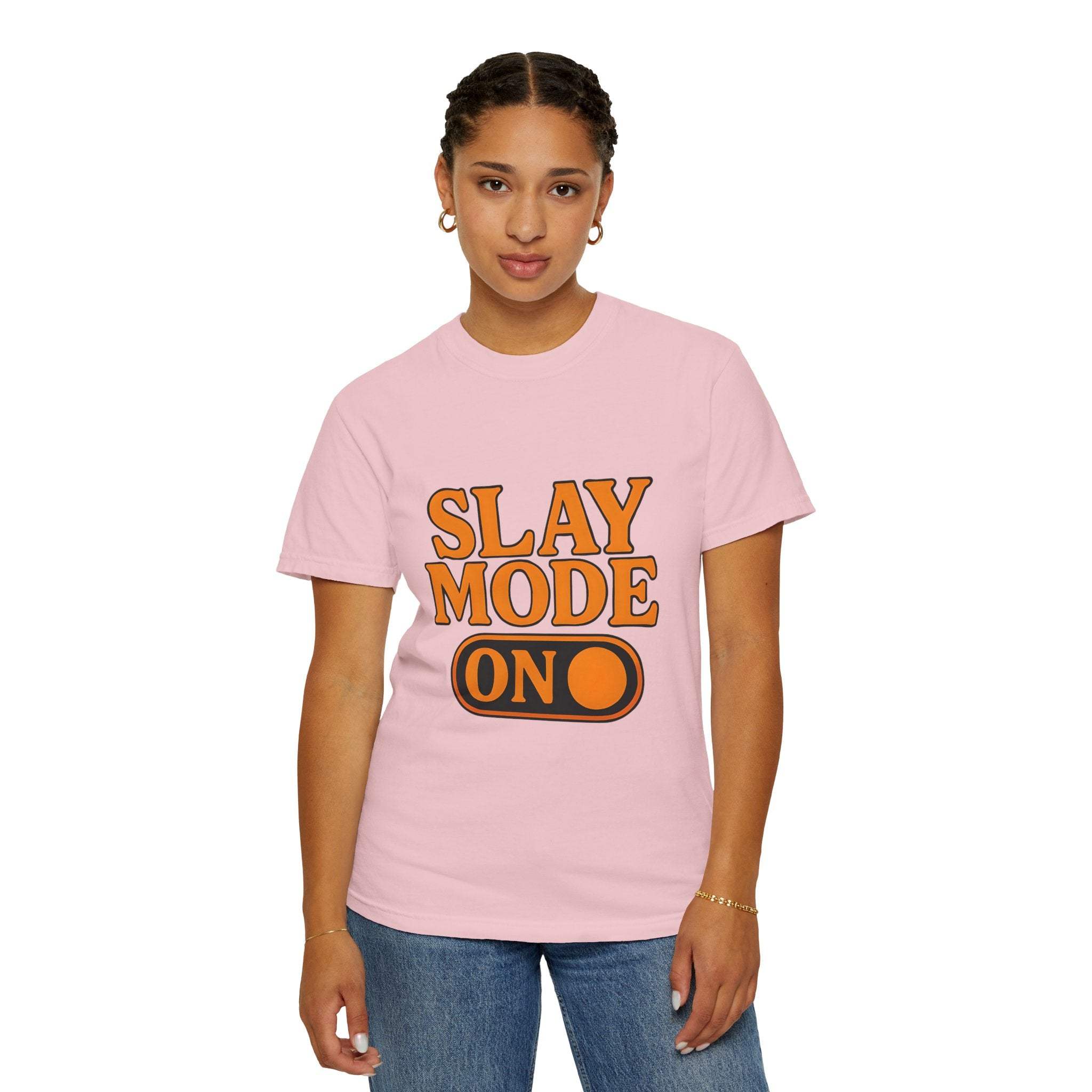 Woman wearing pink garment-dyed tee with "Slay Mode On" text in bold orange letters