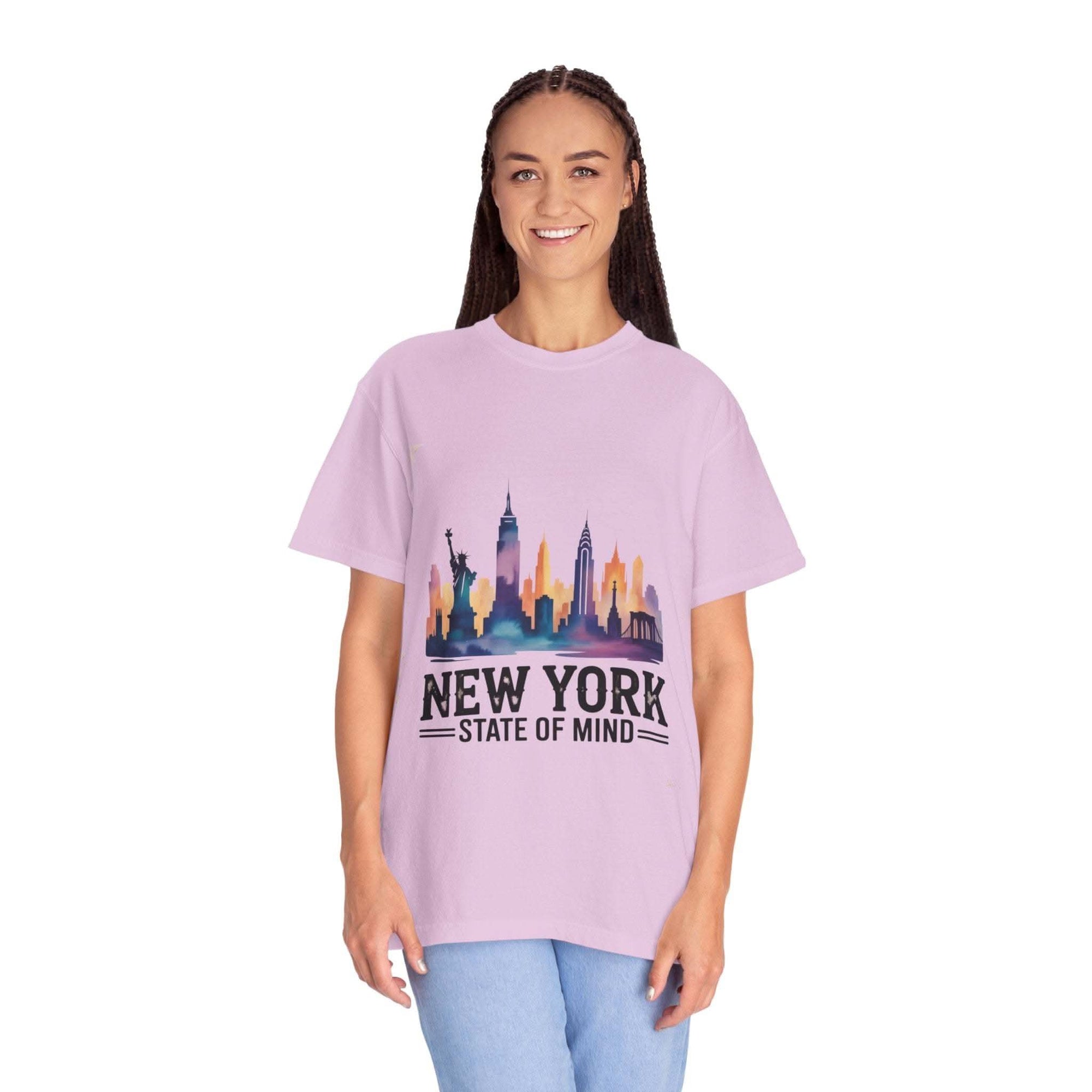 Garment-dyed lilac T-shirt with New York State of Mind graphic and city skyline print worn by smiling woman