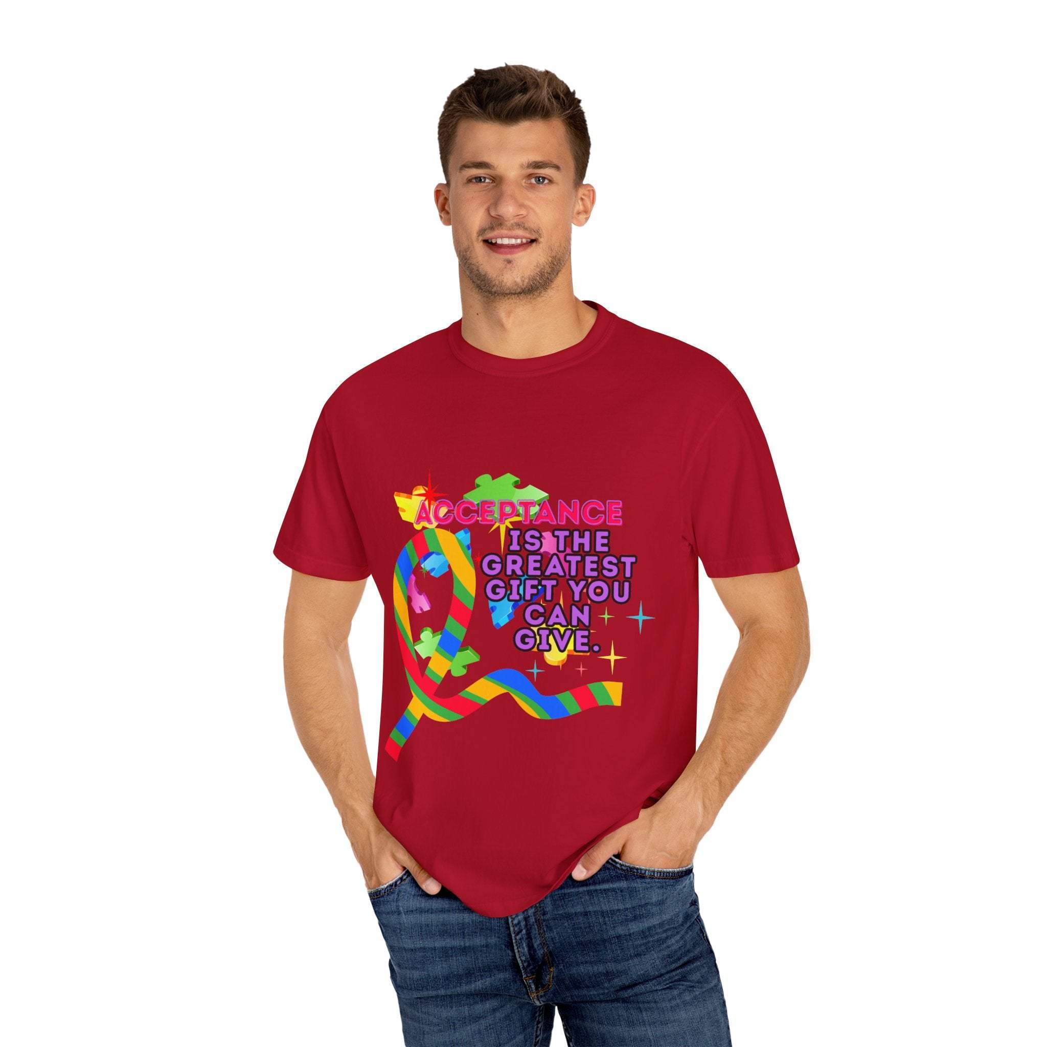 Man wearing red garment-dyed T-shirt with colorful autism acceptance ribbon and text promoting inclusivity and support