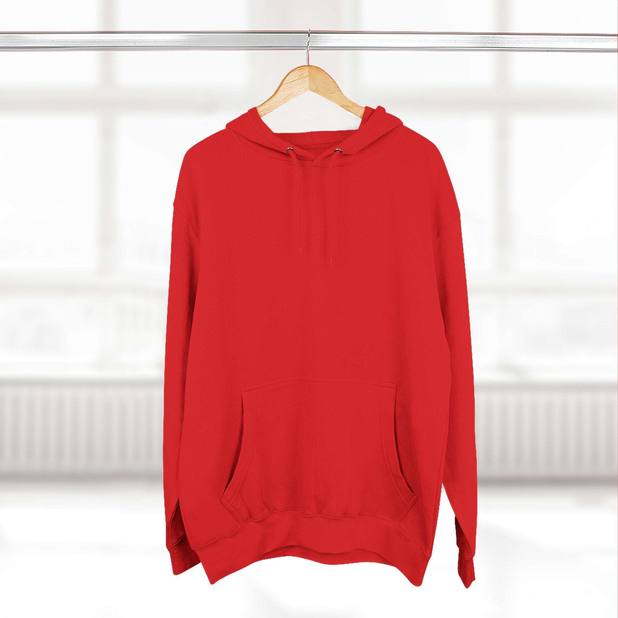 Red fleece hoodie with adjustable hood and kangaroo pocket hanging on wooden hanger