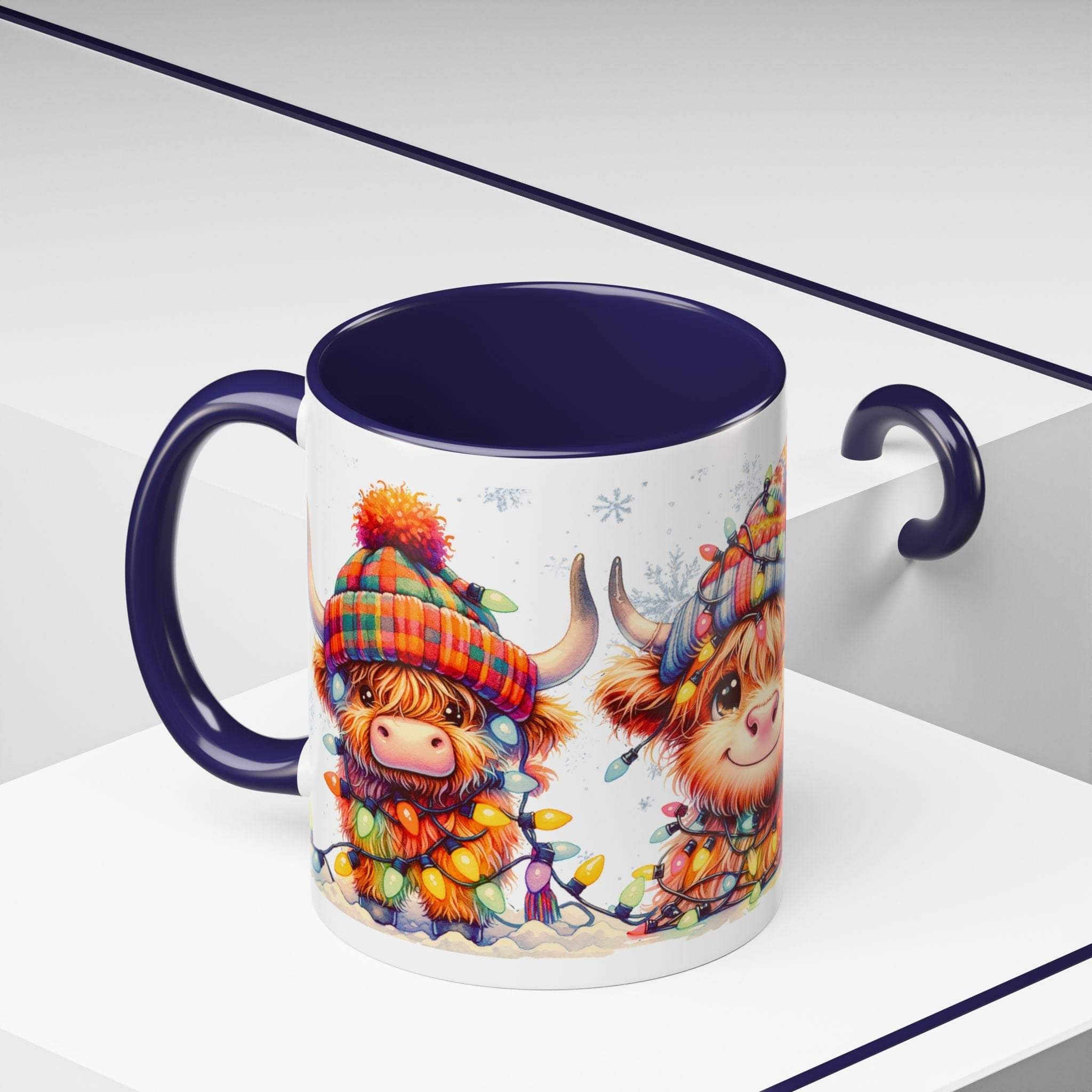 Mug with a design of a Highland cow and a person in a colorful hat, sitting on a white surface.