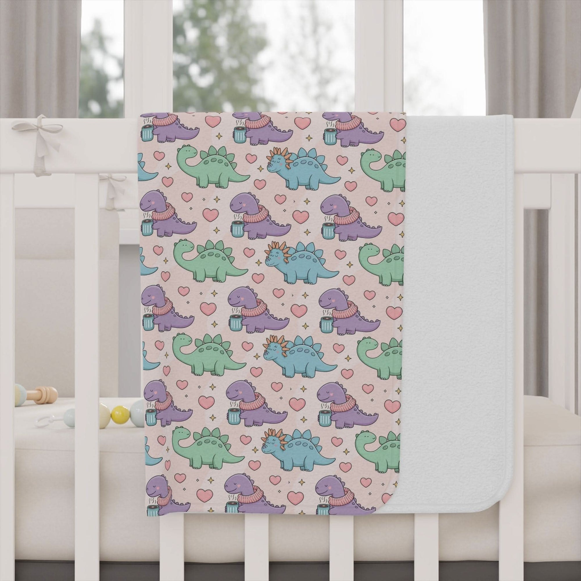 Toddler blanket with pastel dinosaurs wearing scarves, soft and cozy for naptime