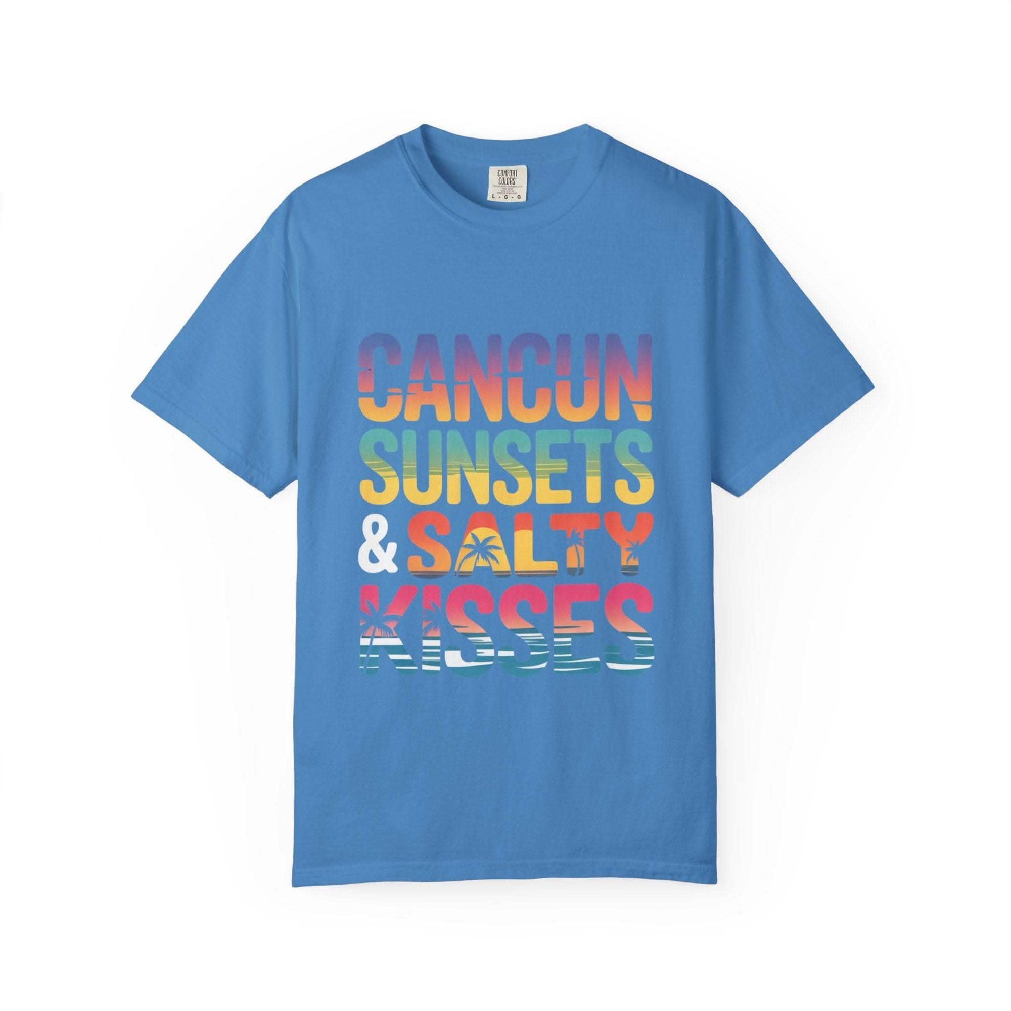 Blue t-shirt with colorful text 'Cancun Sunsets & Salty Kisses' on a white background