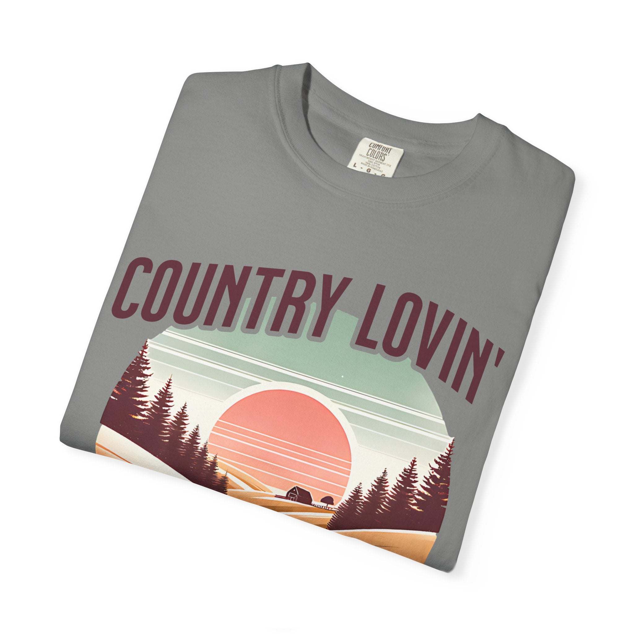 Folded gray Country Lovin Girl T-shirt with vintage sunset and forest graphic