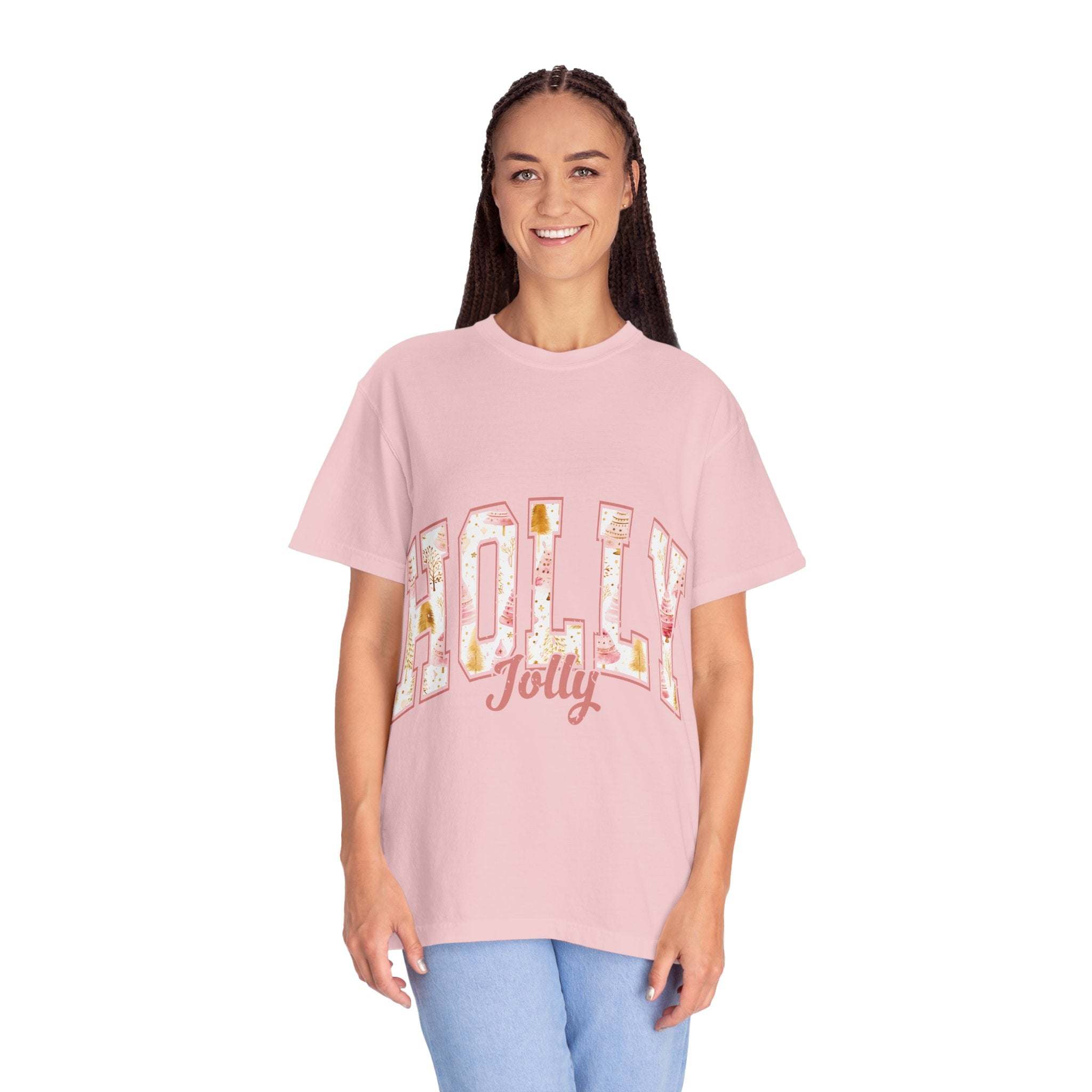 Woman wearing pink Varsity Holly Jolly T-shirt with festive lettering on front