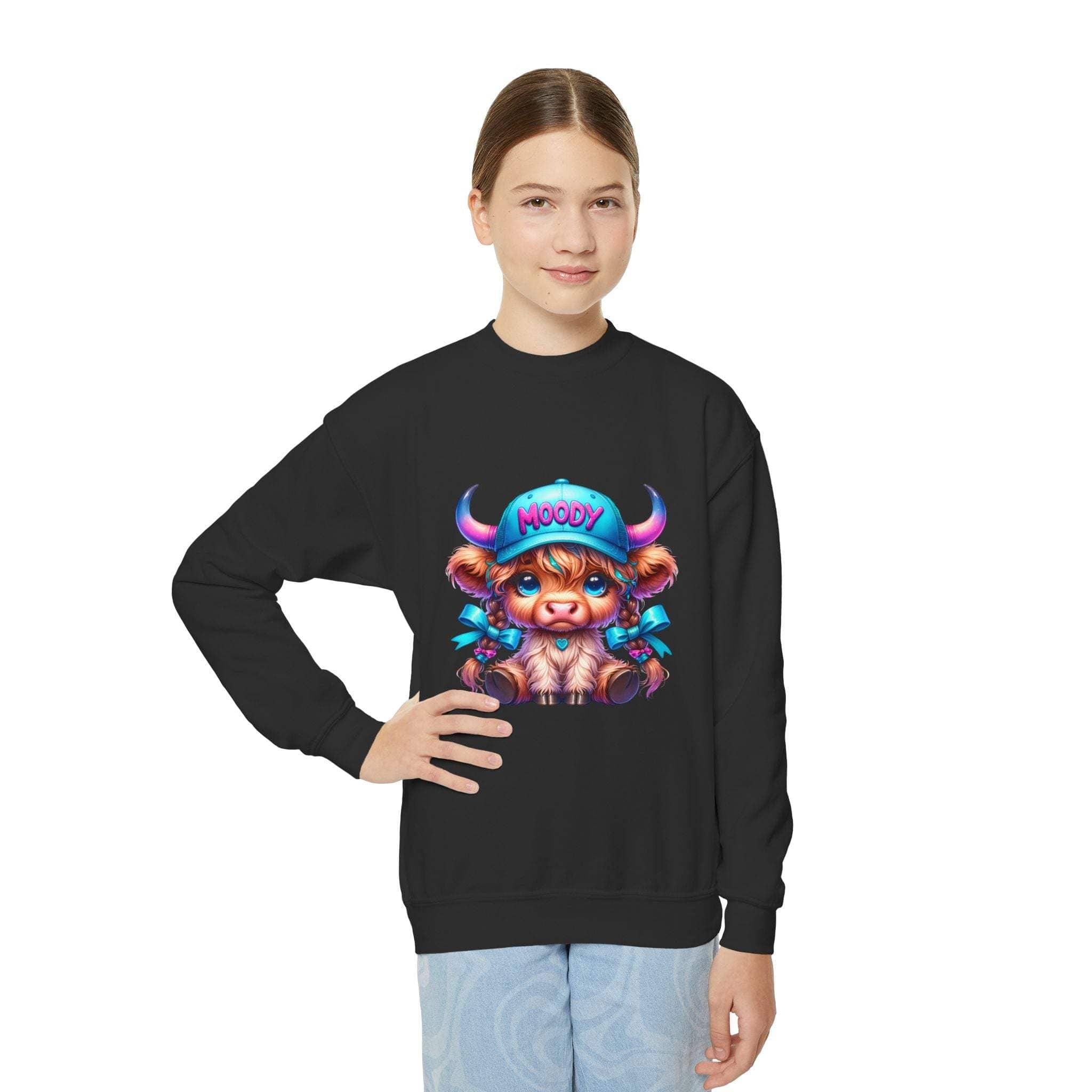 Youth wearing black Moody Girl Highland Cow sweatshirt with colorful cartoon cow design on front