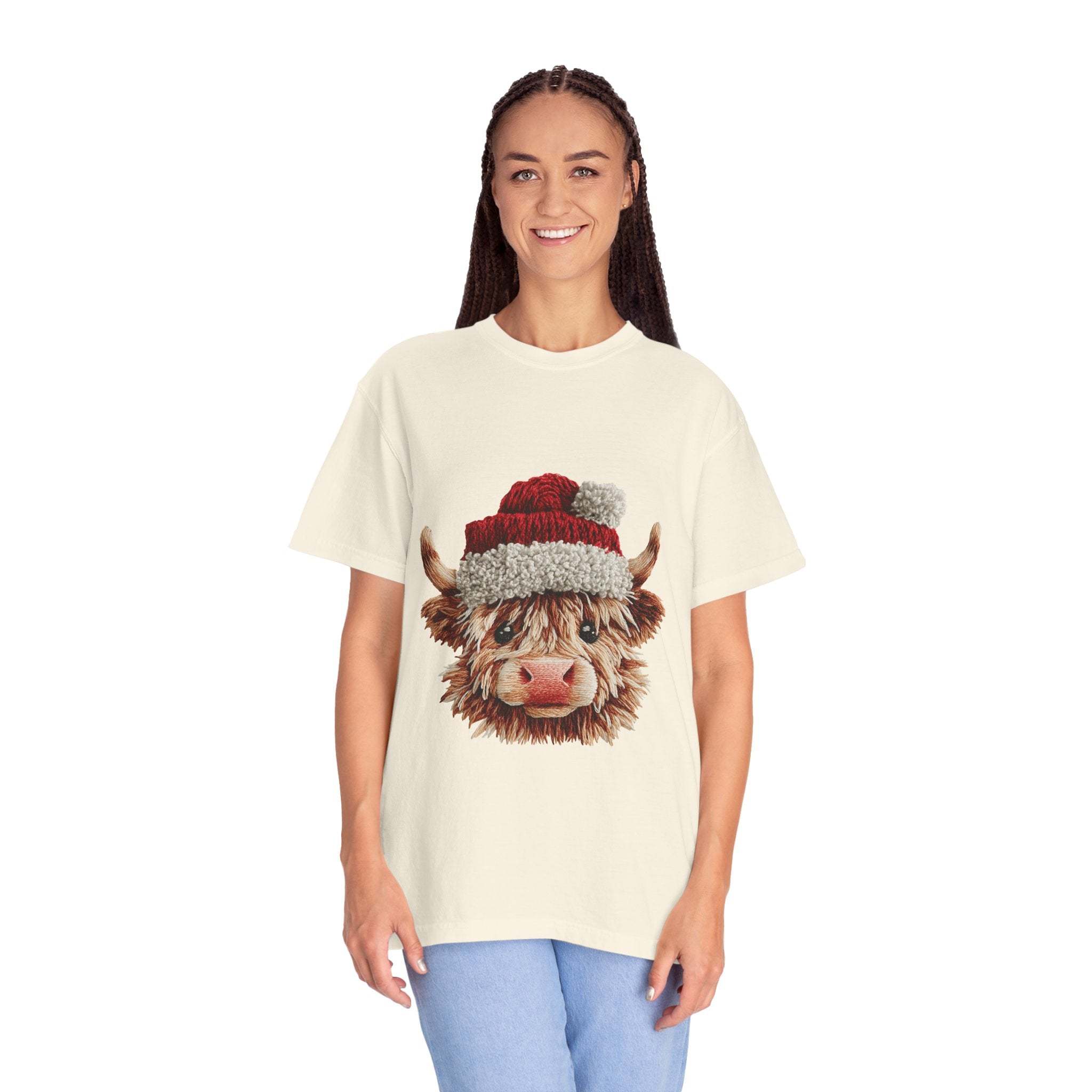 Woman wearing cream t-shirt with faux crochet yarn Highland cow Santa print for Christmas