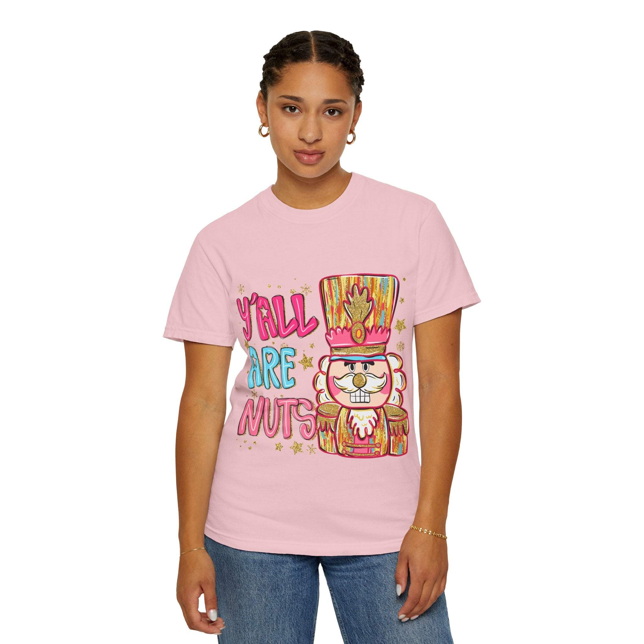 Woman wearing pink Yall Are Nuts Nutcracker festive t-shirt with playful holiday design