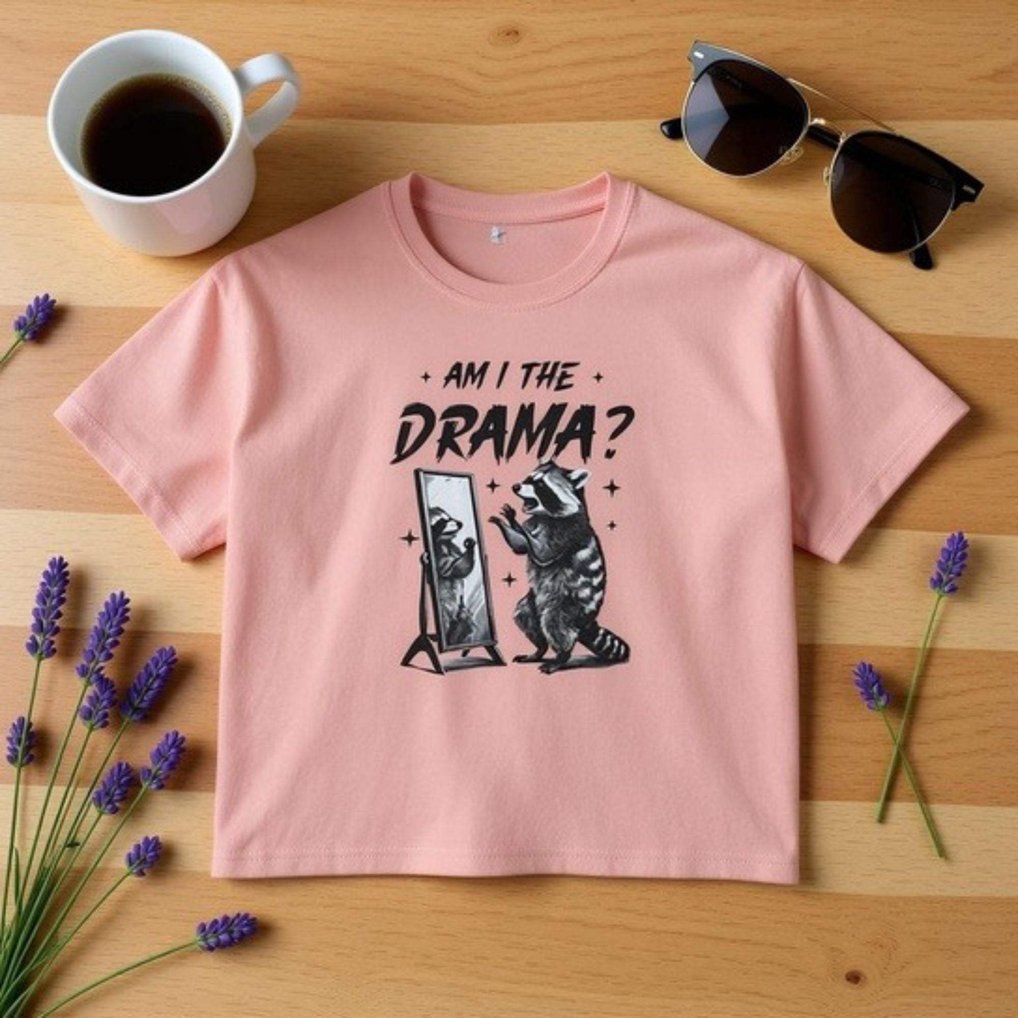 Pink Boxy Tee with "Am I The Drama?" graphic and raccoon illustration on front
