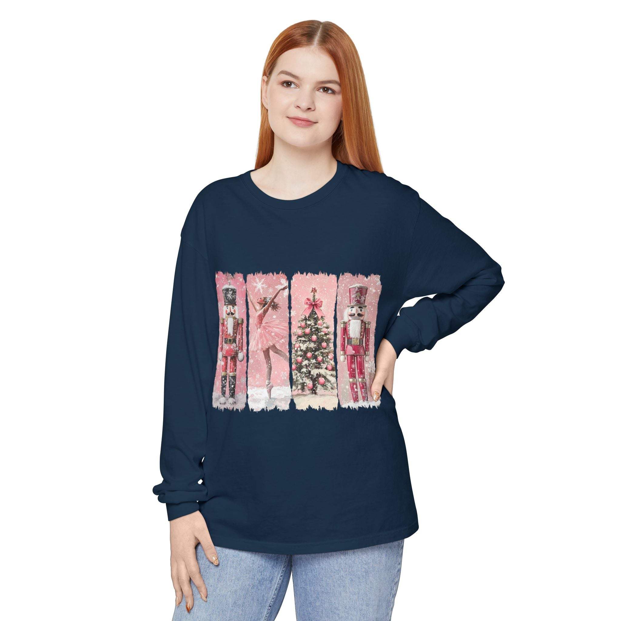 Woman wearing navy long sleeve t-shirt with pink watercolor nutcracker Christmas design