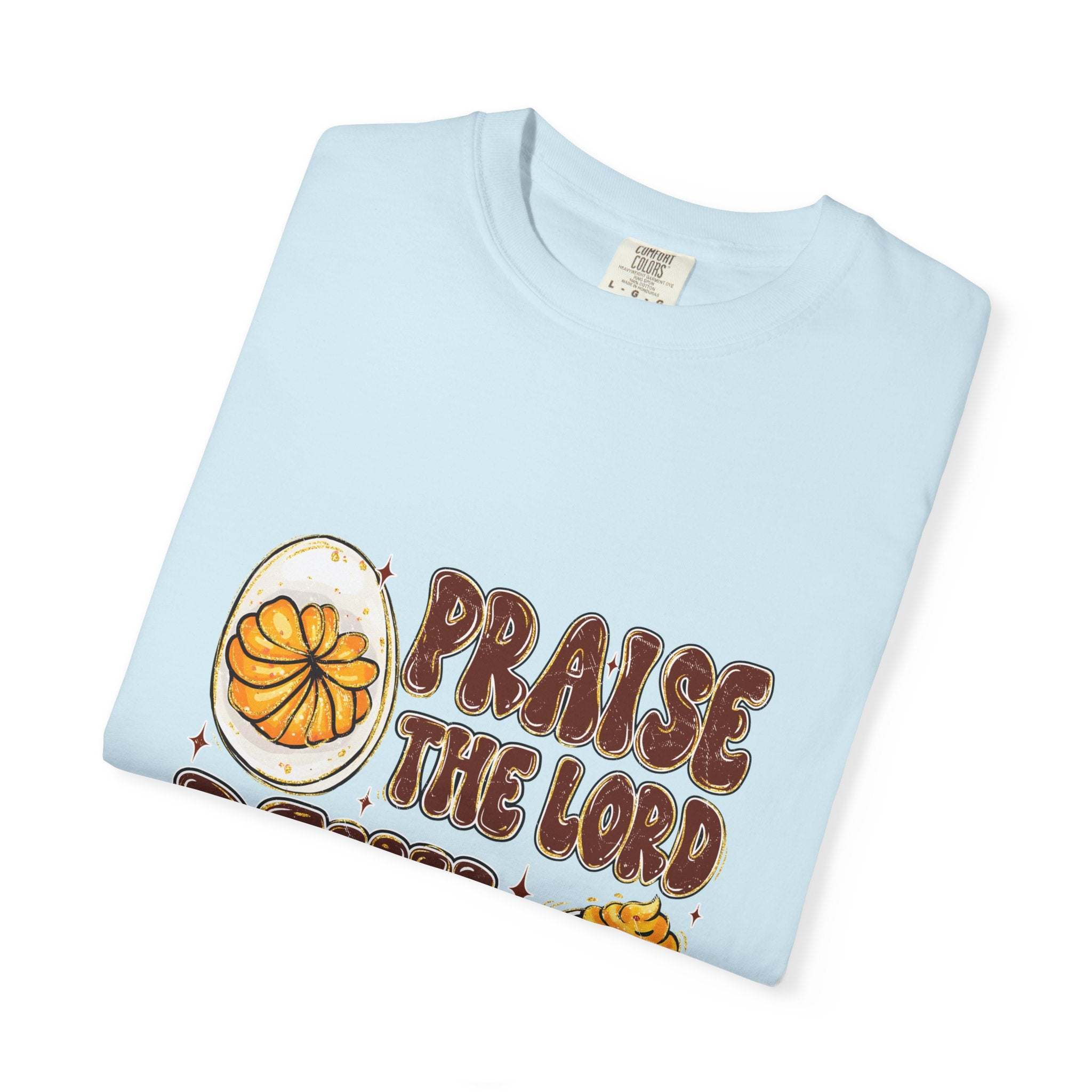 White cotton t-shirt featuring 'Praise the Lord, Devil the Eggs' design, perfect for Easter and Christian apparel.