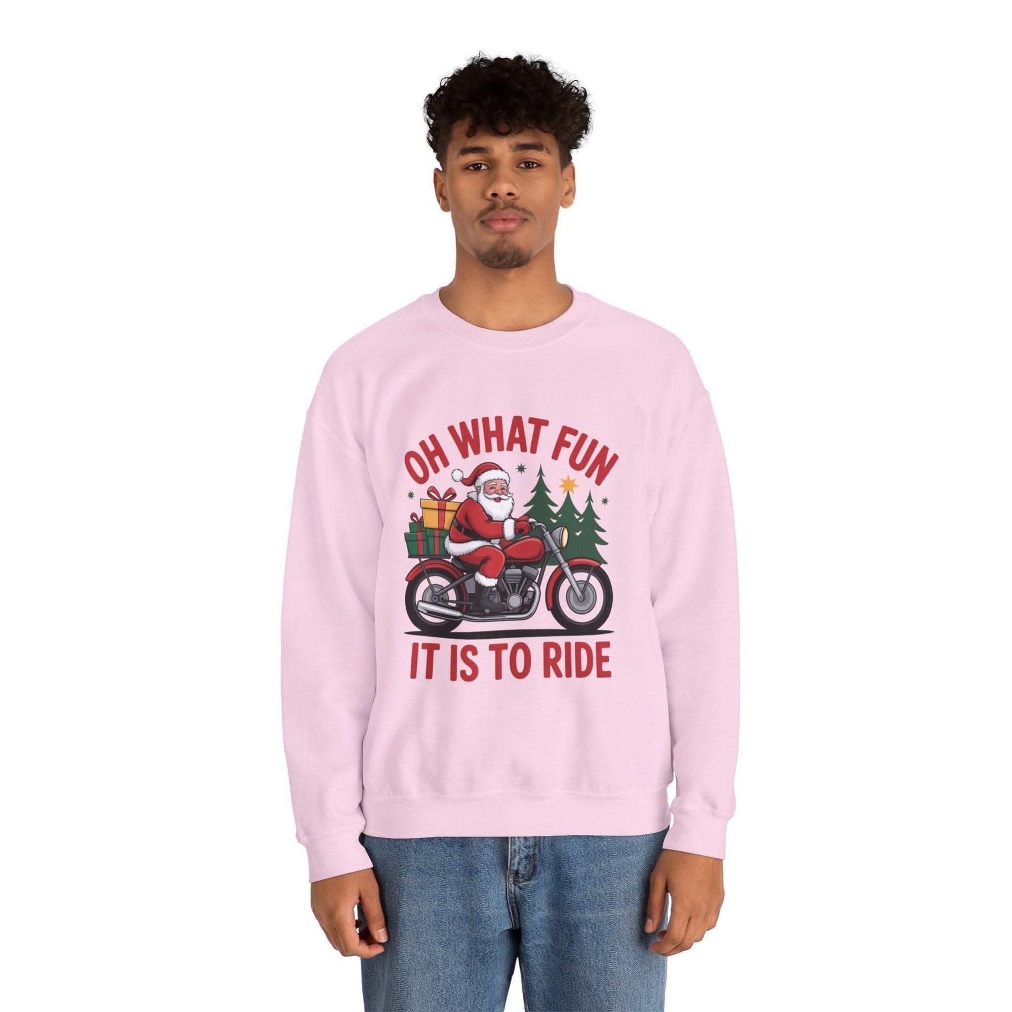 Man wearing navy Motorcycle Santa Sweatshirt with Santa on motorcycle and holiday gifts design in festive setting