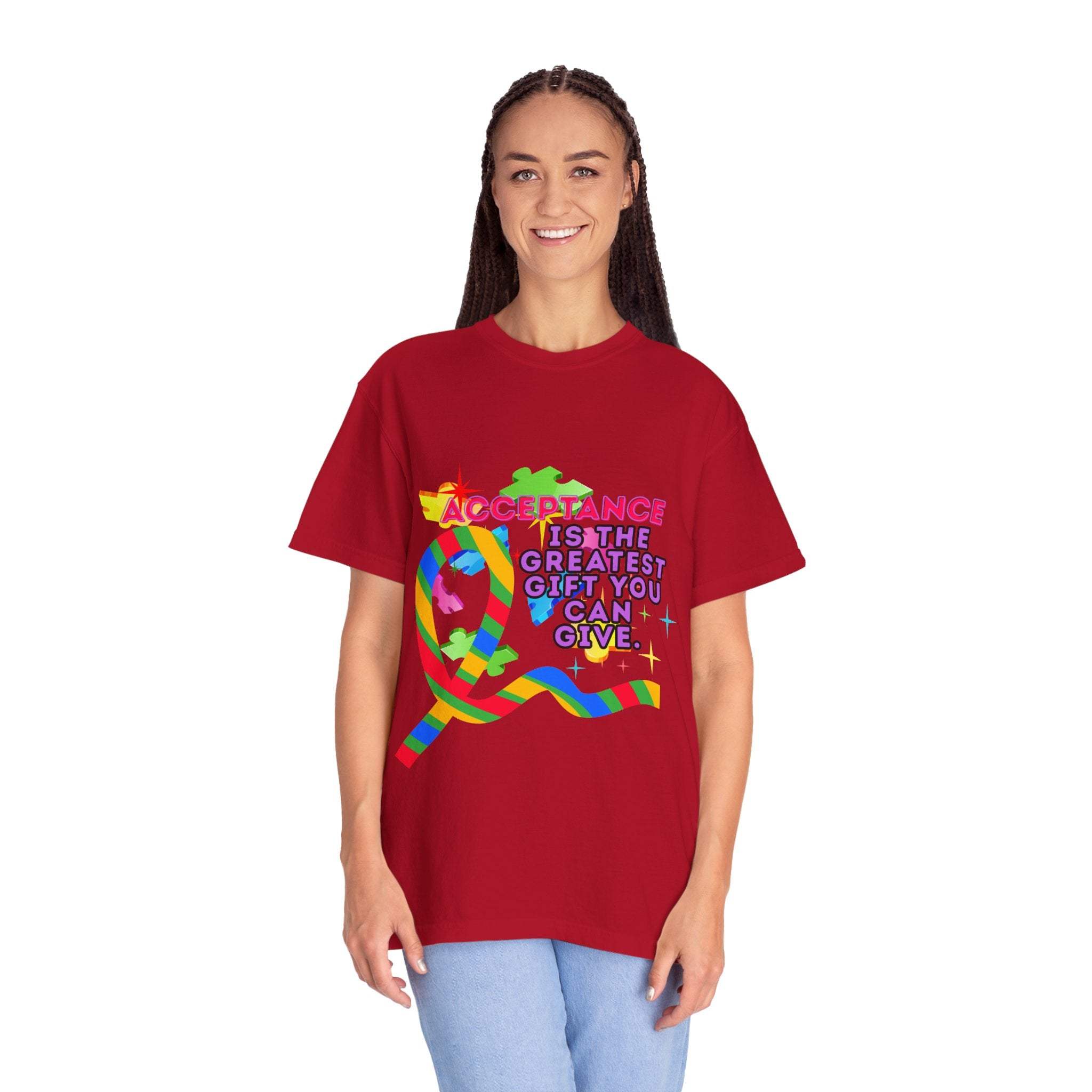 Woman wearing red garment-dyed T-shirt with colorful Autism Acceptance ribbon and supportive message on front