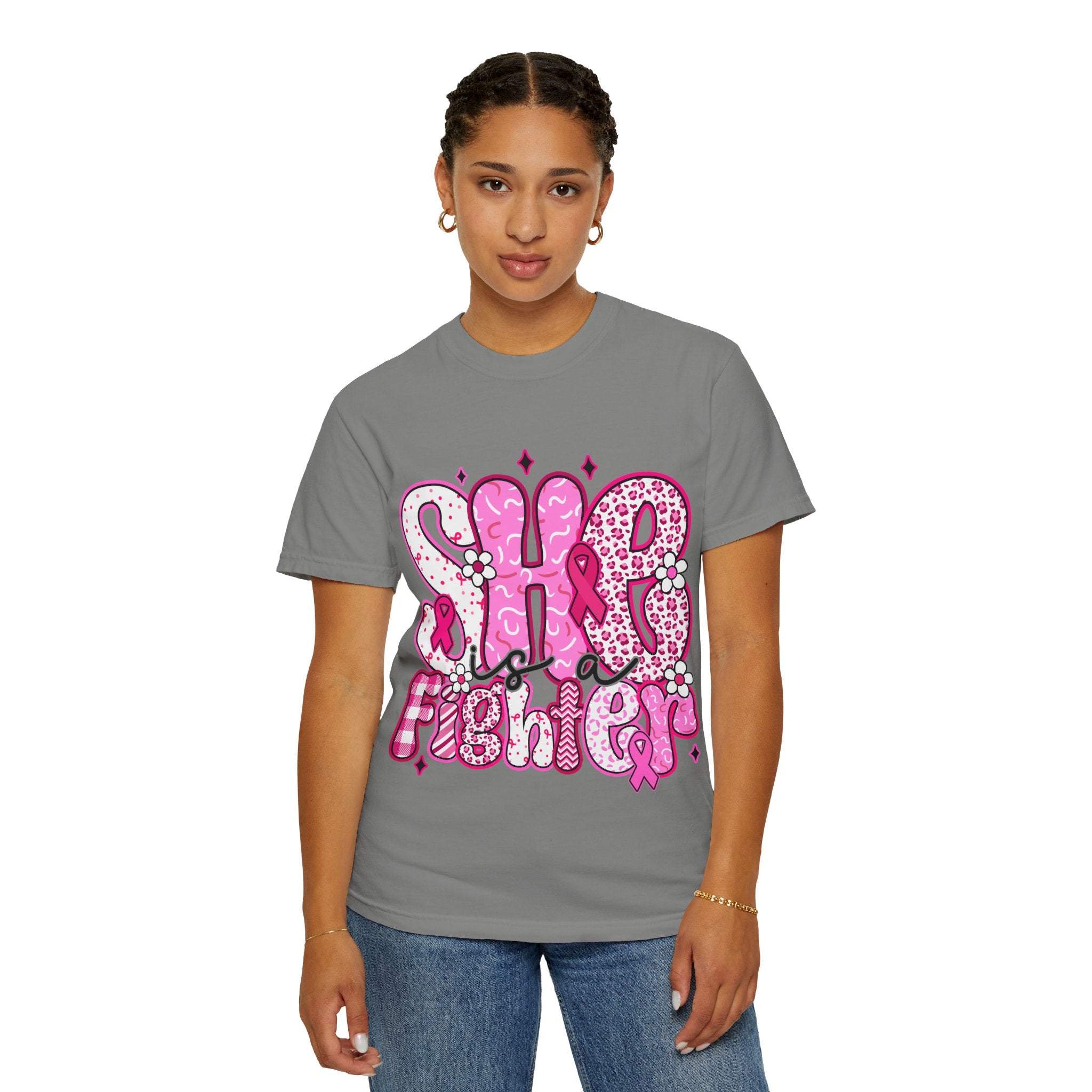 Woman wearing gray Fighter Breast Cancer T-shirt with pink "She is a Fighter" design