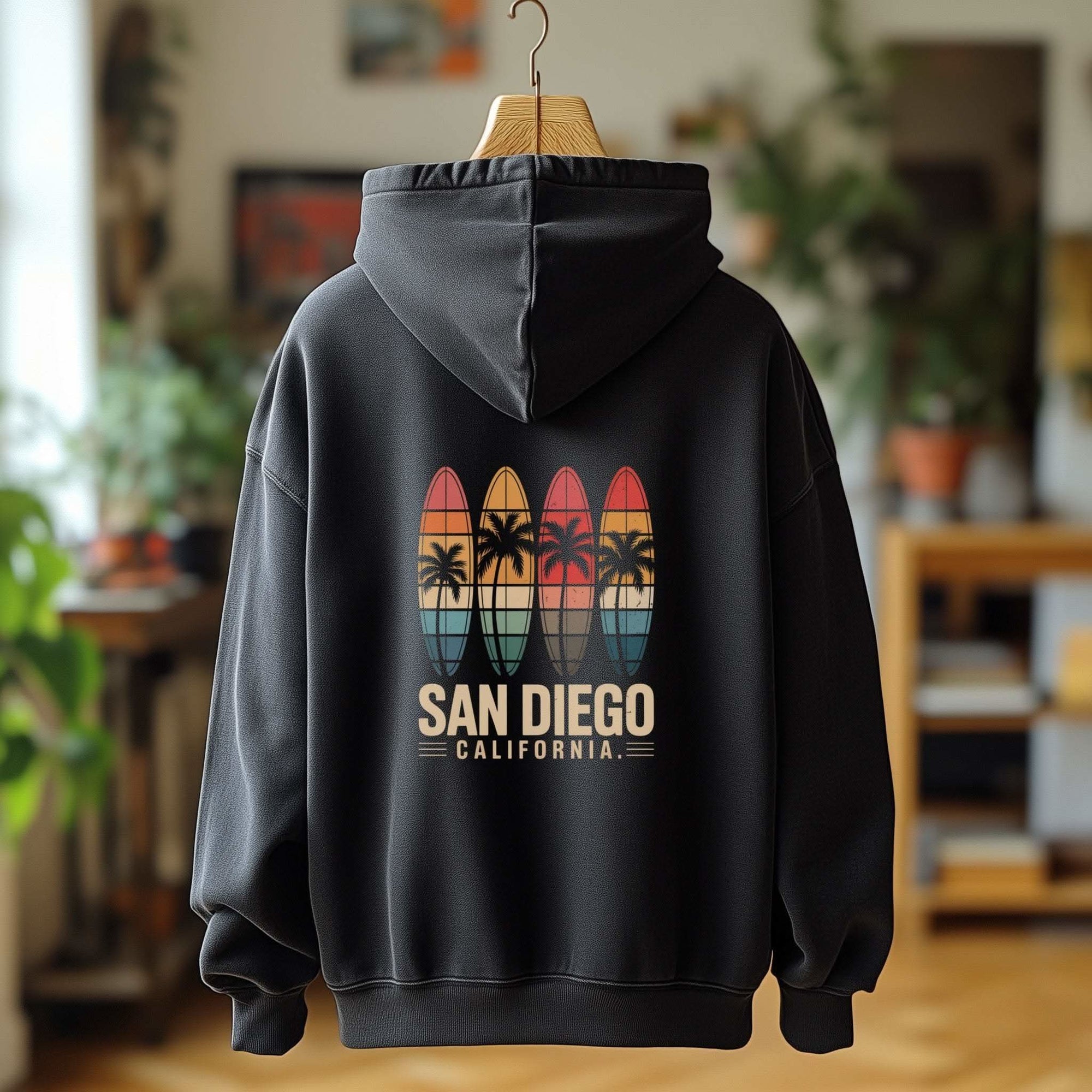 Retro San Diego surfboard graphic fleece hoodie with kangaroo pocket and adjustable hood on sandy beach background