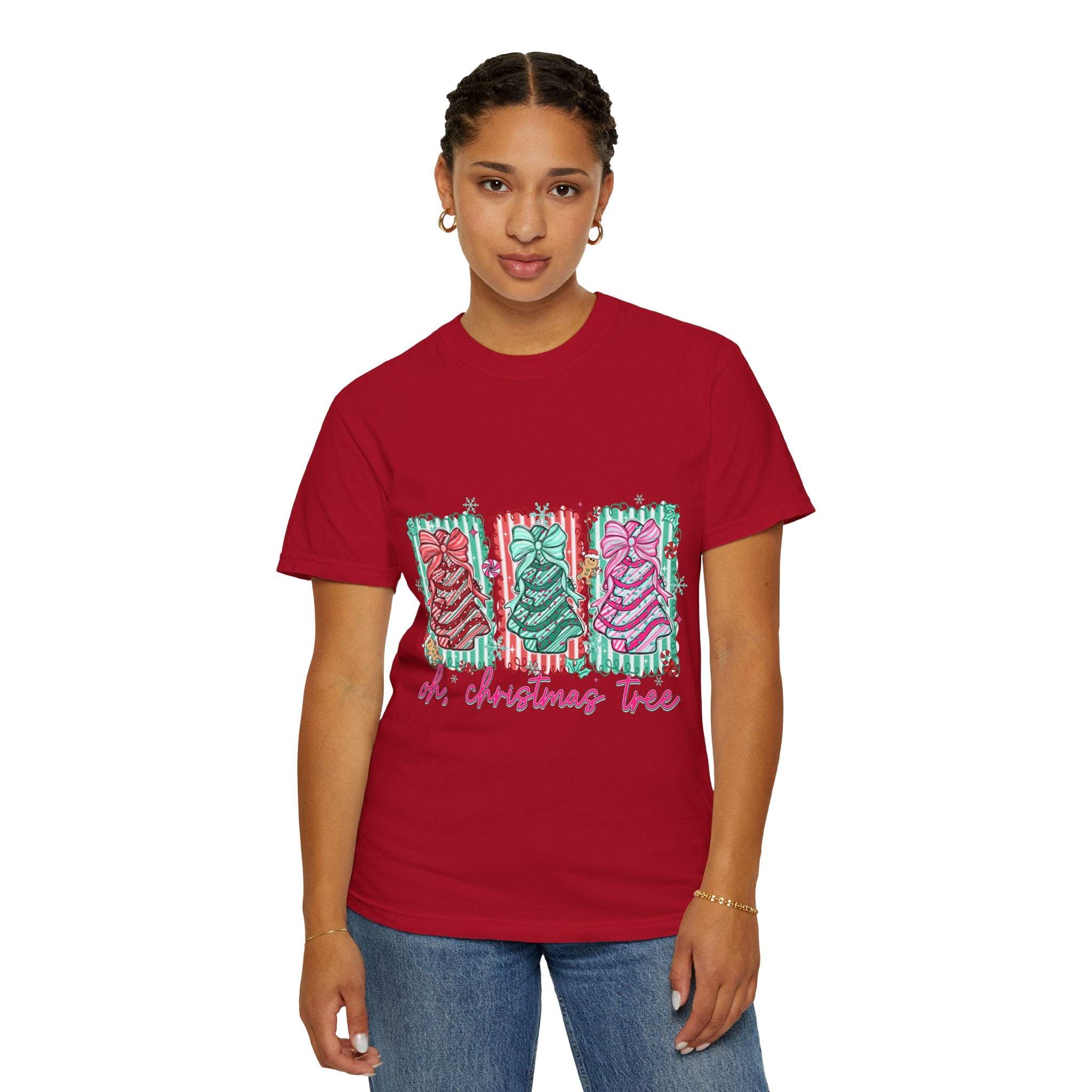 Woman wearing red Oh Christmas Tree T-shirt with festive tree designs and text.