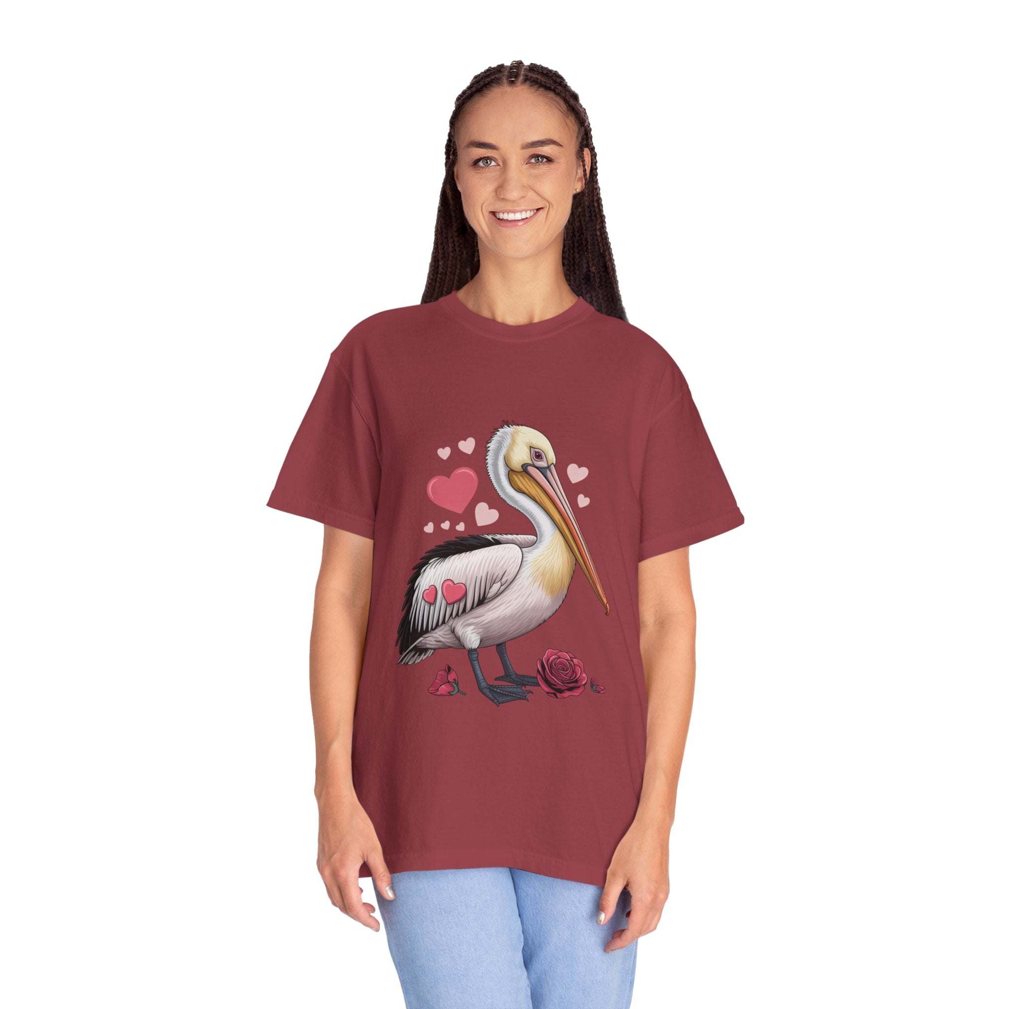 Woman wearing a maroon t-shirt with a pelican design on a white background
