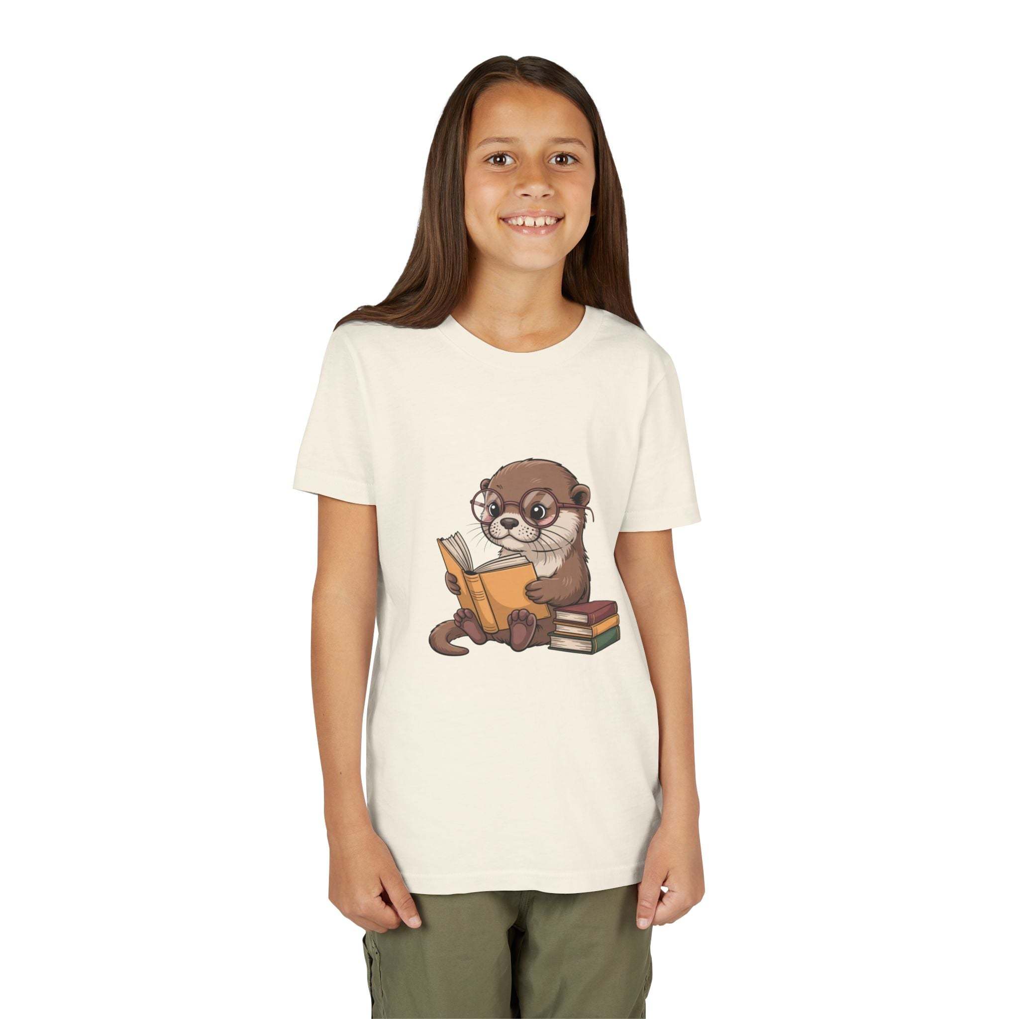Young girl wearing a t-shirt with an otter holding books graphic on a white background
