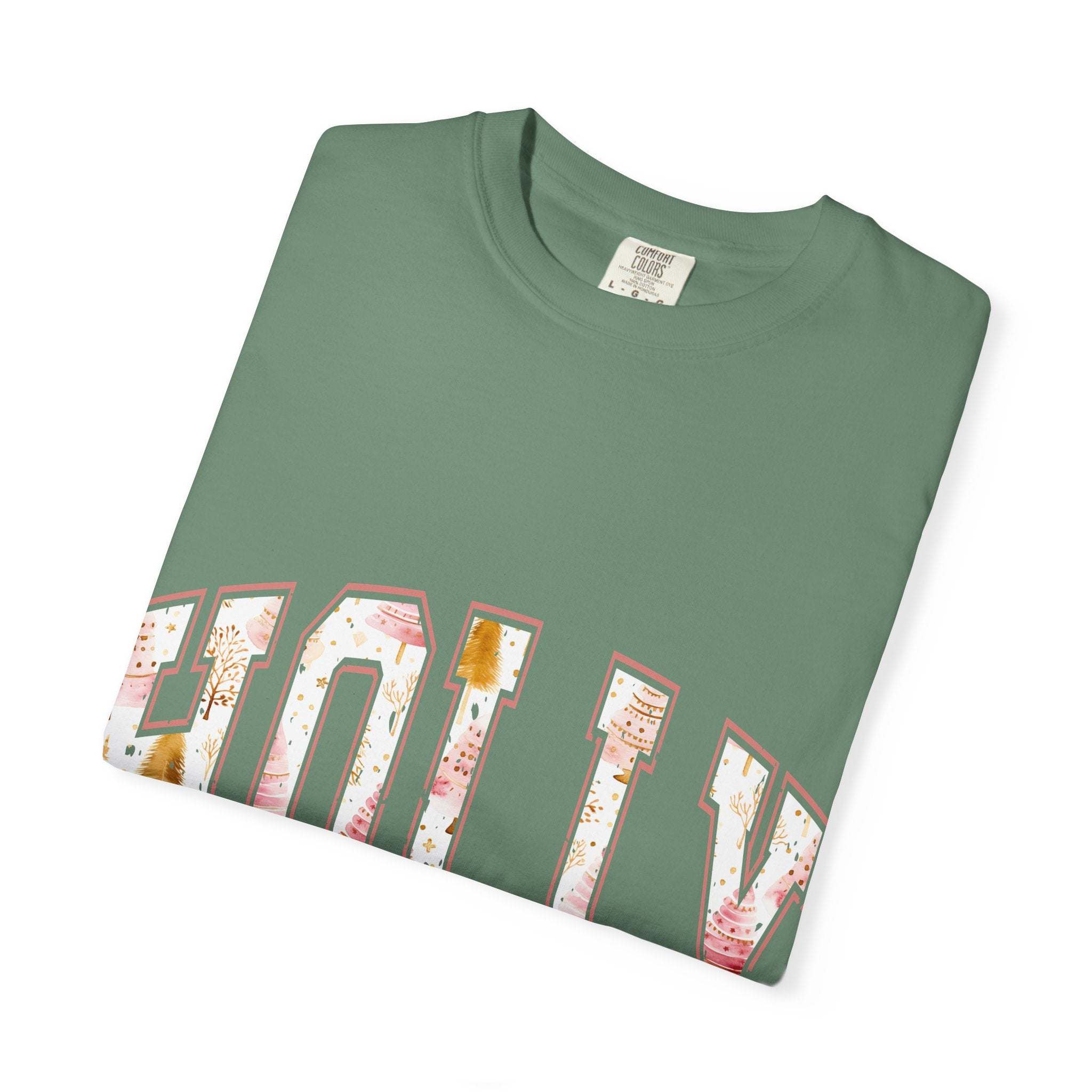 Folded green Varsity Holly Jolly T-shirt with festive lettering and made of 100% ring-spun cotton.