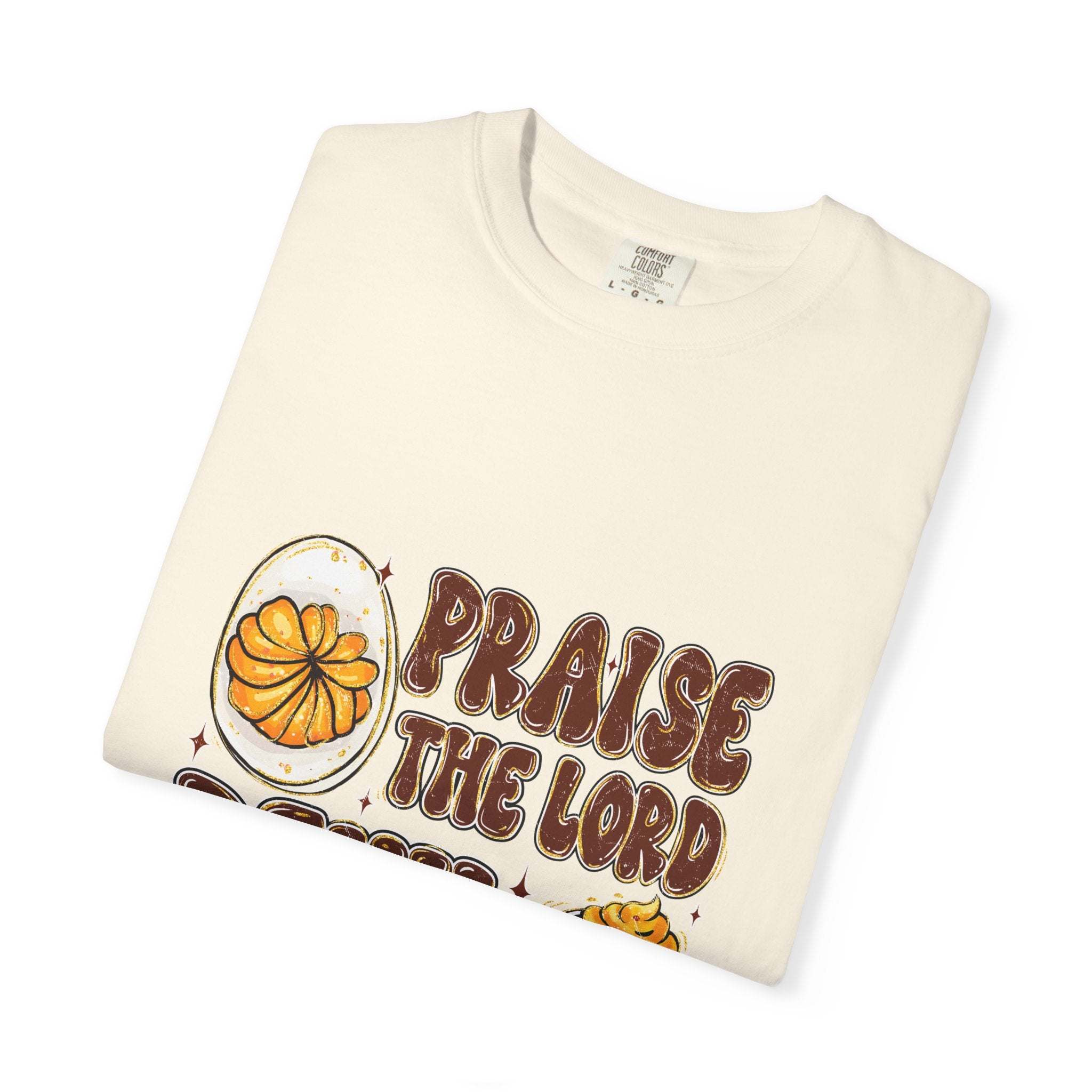White cotton t-shirt featuring 'Praise the Lord, Devil the Eggs' design, perfect for Easter and Christian apparel.