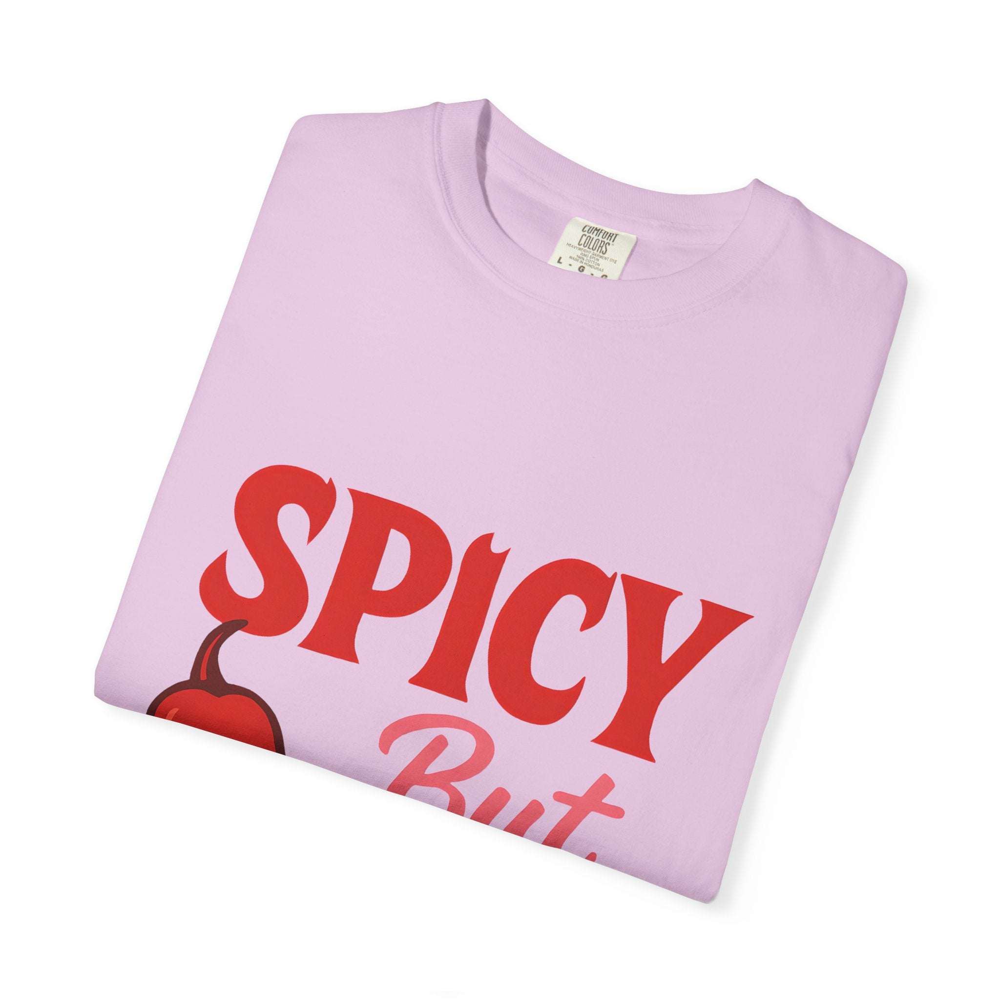 Folded light purple unisex Spicy But Sweet T-shirt with bold red text and chili graphic, made from soft garment-dyed cotton