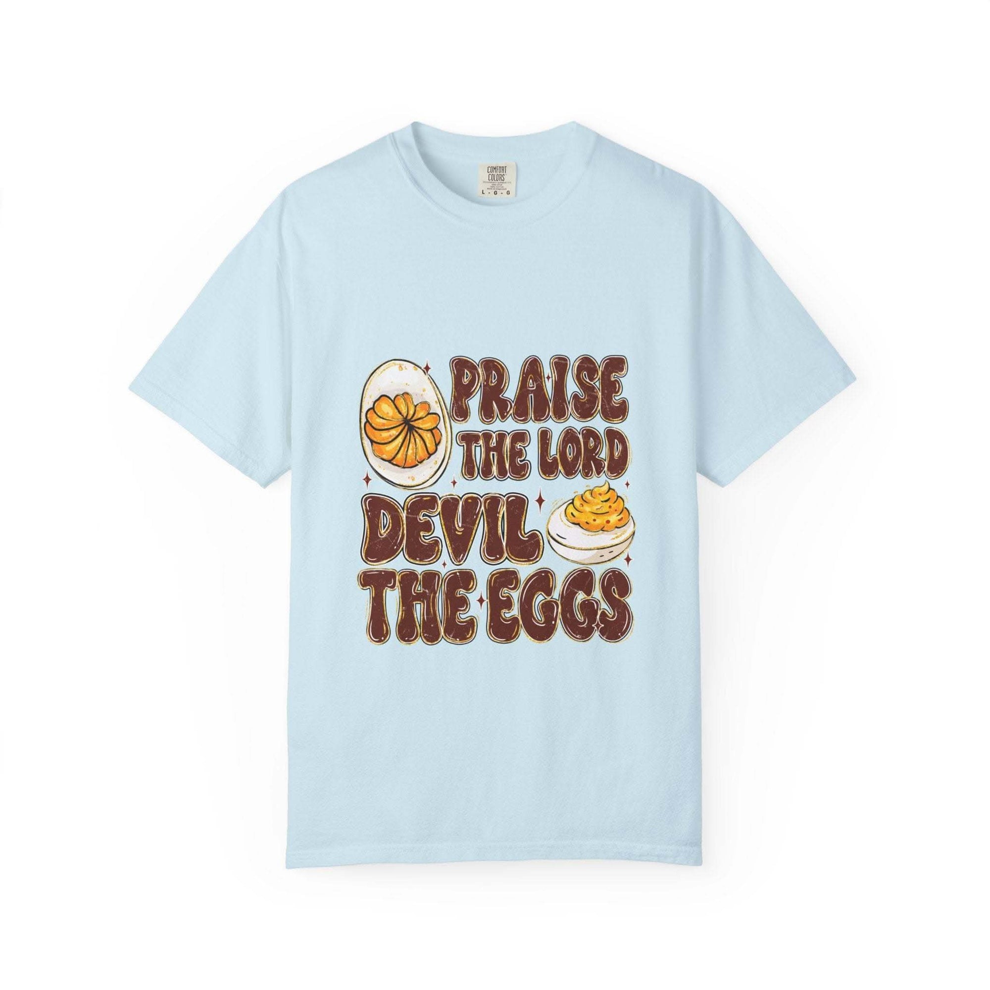 White cotton t-shirt featuring 'Praise the Lord, Devil the Eggs' design, perfect for Easter and Christian apparel.