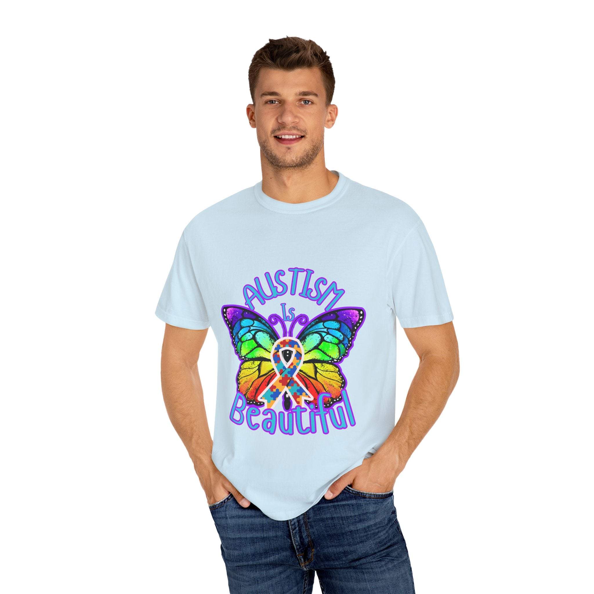 Man wearing light blue Autism is Beautiful T-shirt with colorful butterfly and autism awareness ribbon design