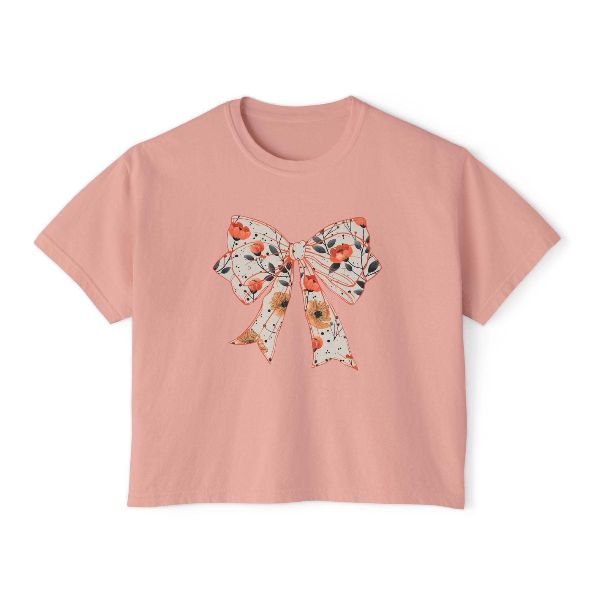 Womens floral coquette bow design tee in butter color, boxy fit, made from vintage cotton by Printify
