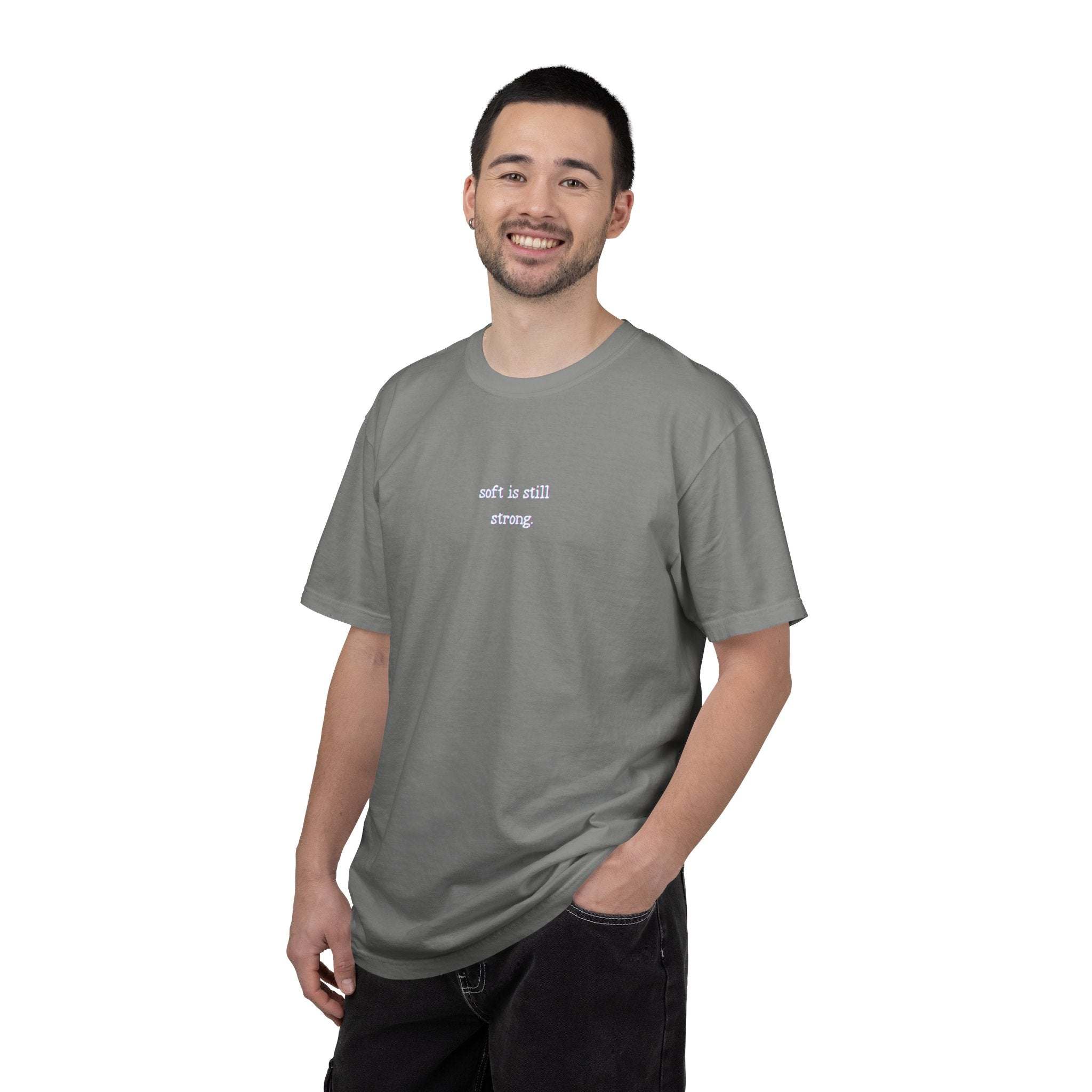 Man wearing a gray t-shirt with text on a white background