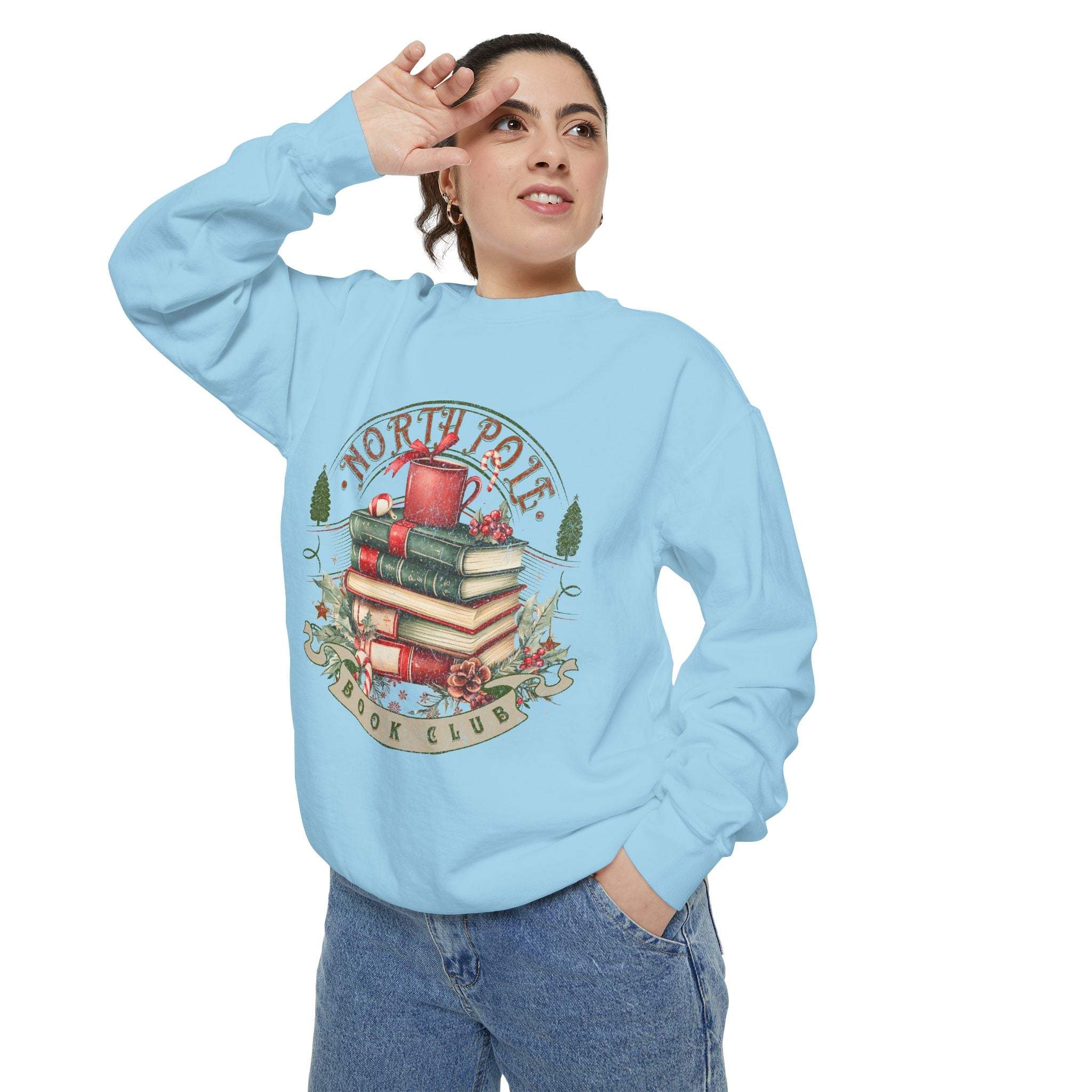 Woman wearing light blue Vintage North Pole Book Club sweatshirt with holiday-themed book stack design