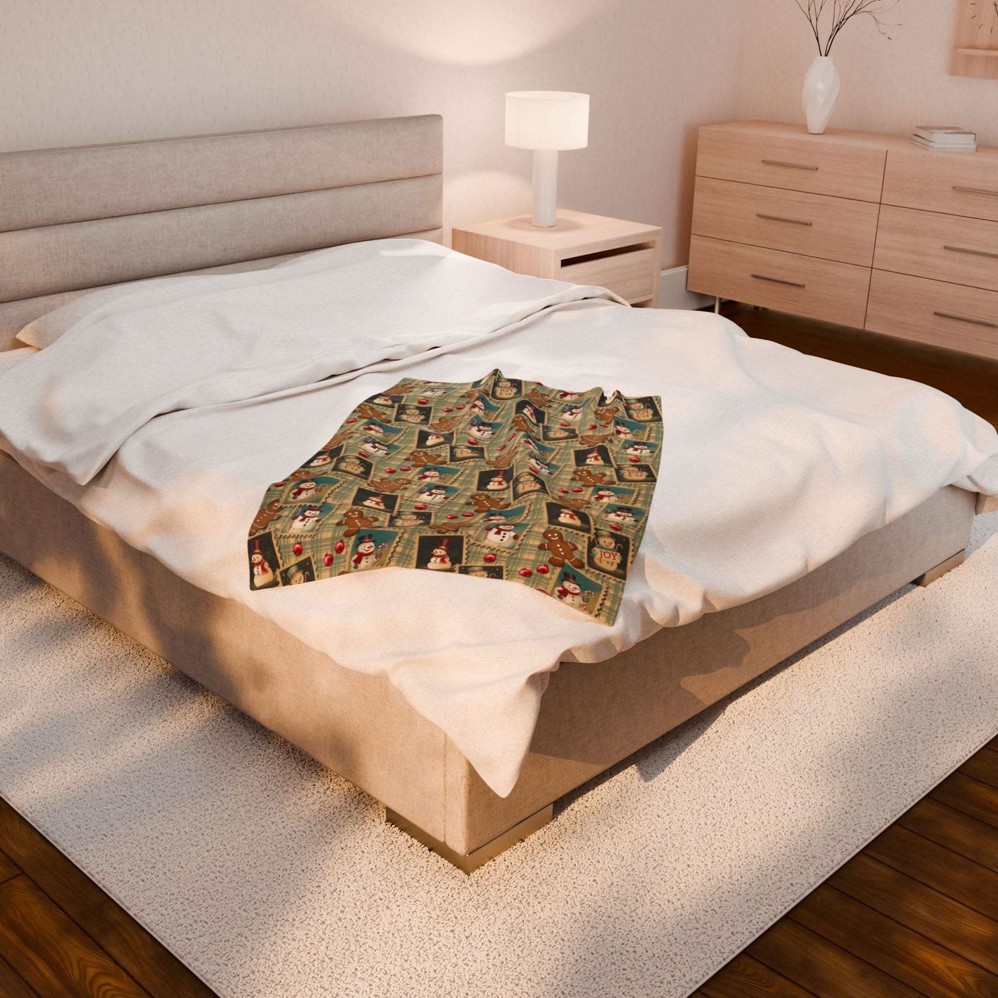 Plush blanket with retro Christmas watercolor design on bed in cozy bedroom setting