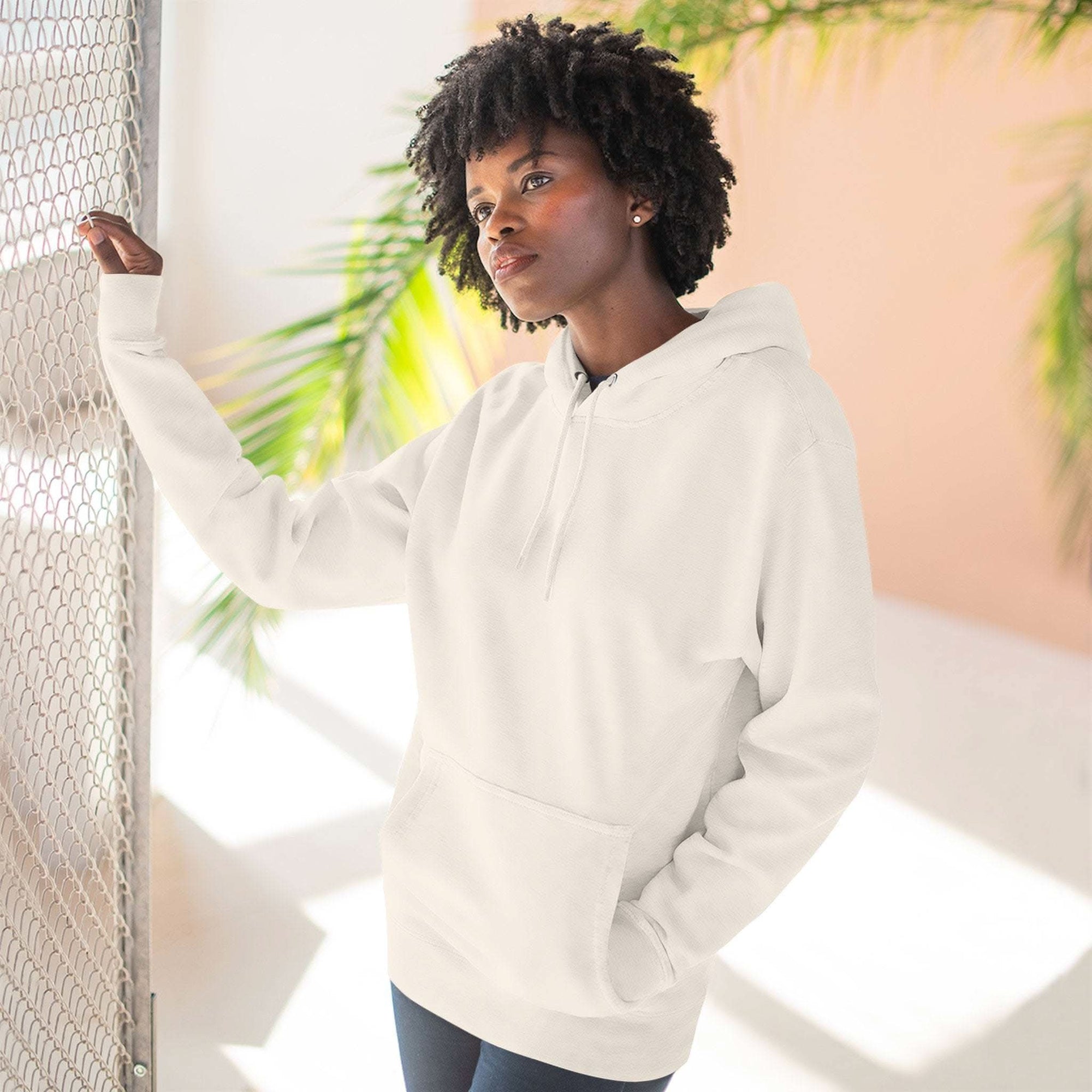 woman wearing plain white fleece hoodie with kangaroo pocket and adjustable hood indoors