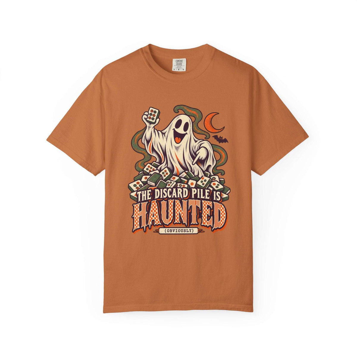 Yam orange Comfort Colors 1717 Halloween mahjong T-shirt with a ghost holding a tile and “The Discard Pile Is Haunted (Obviously)” lettering.