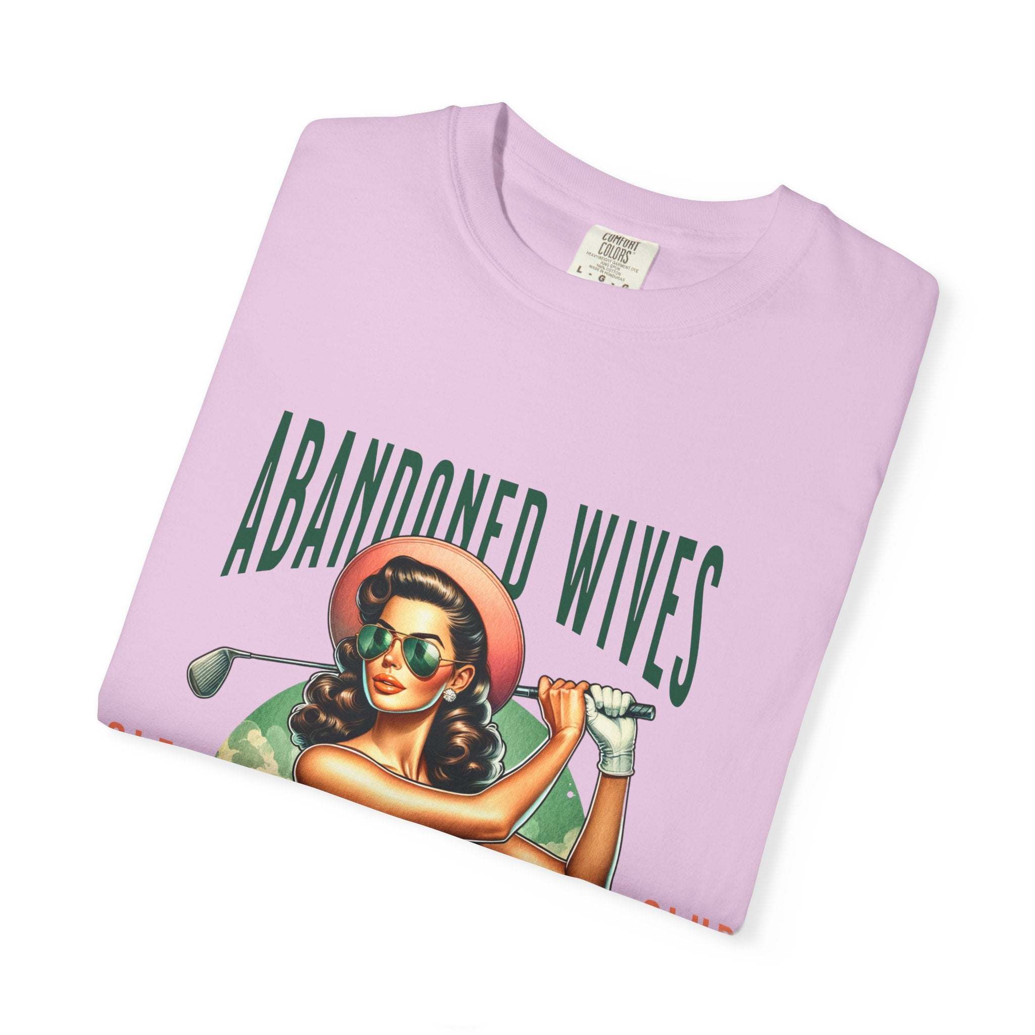 Vintage unisex t-shirt with humorous Abandoned Wives Golf Club design in pink with retro styled female golfer illustration