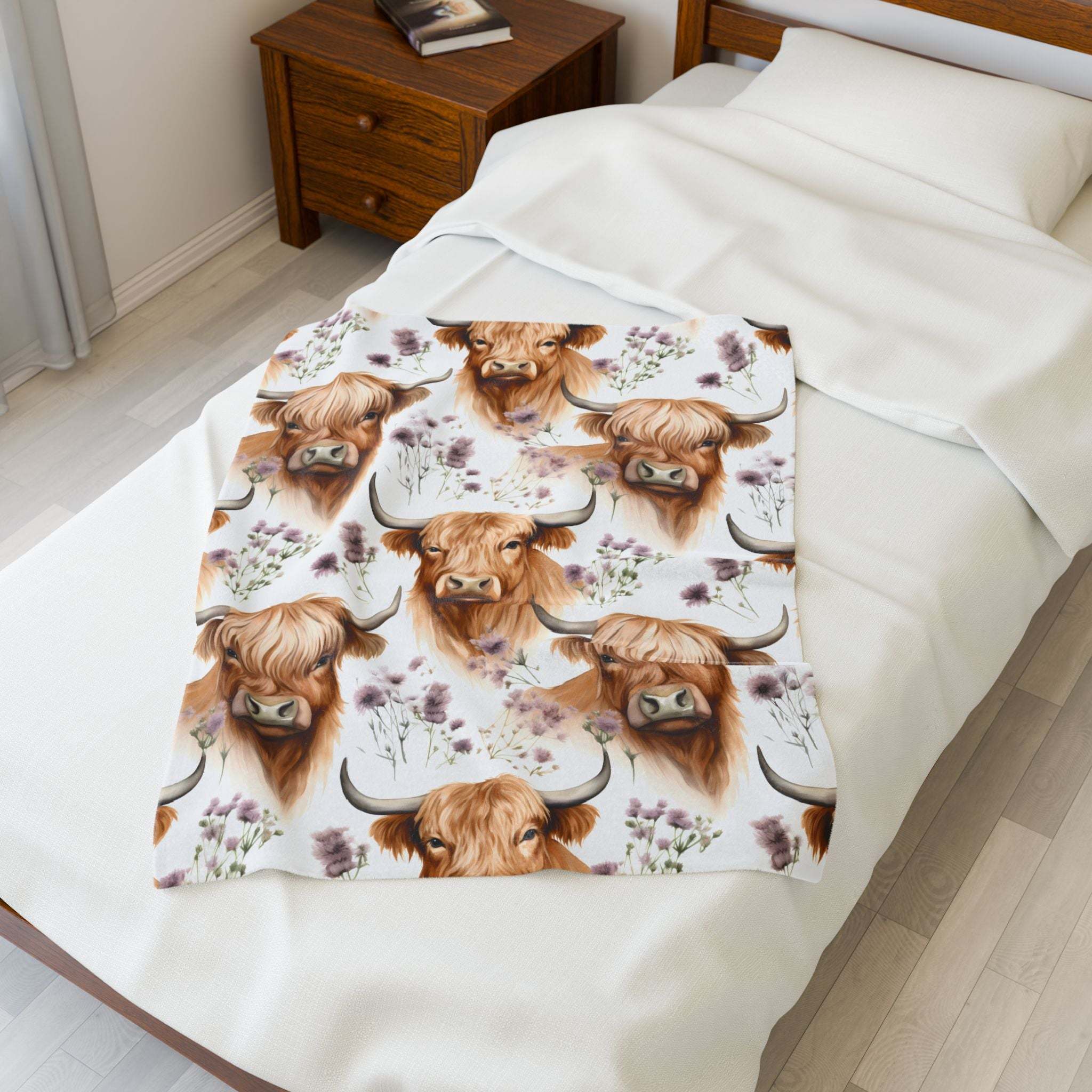 Velveteen plush blanket with floral highland cow design on bed