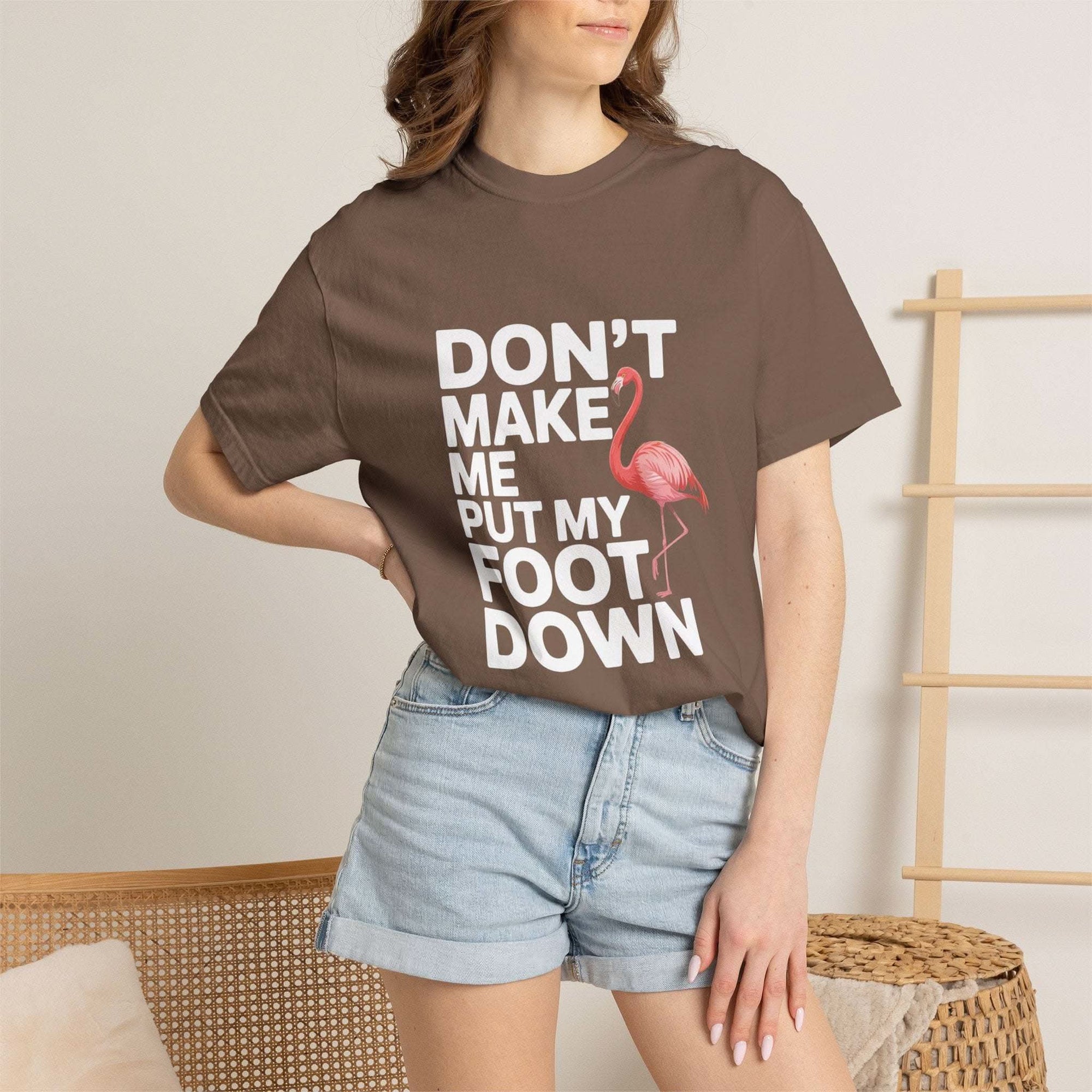 Dont Make Me Put My Foot Down flamingo graphic on vintage-style pink T-shirt with bold white text