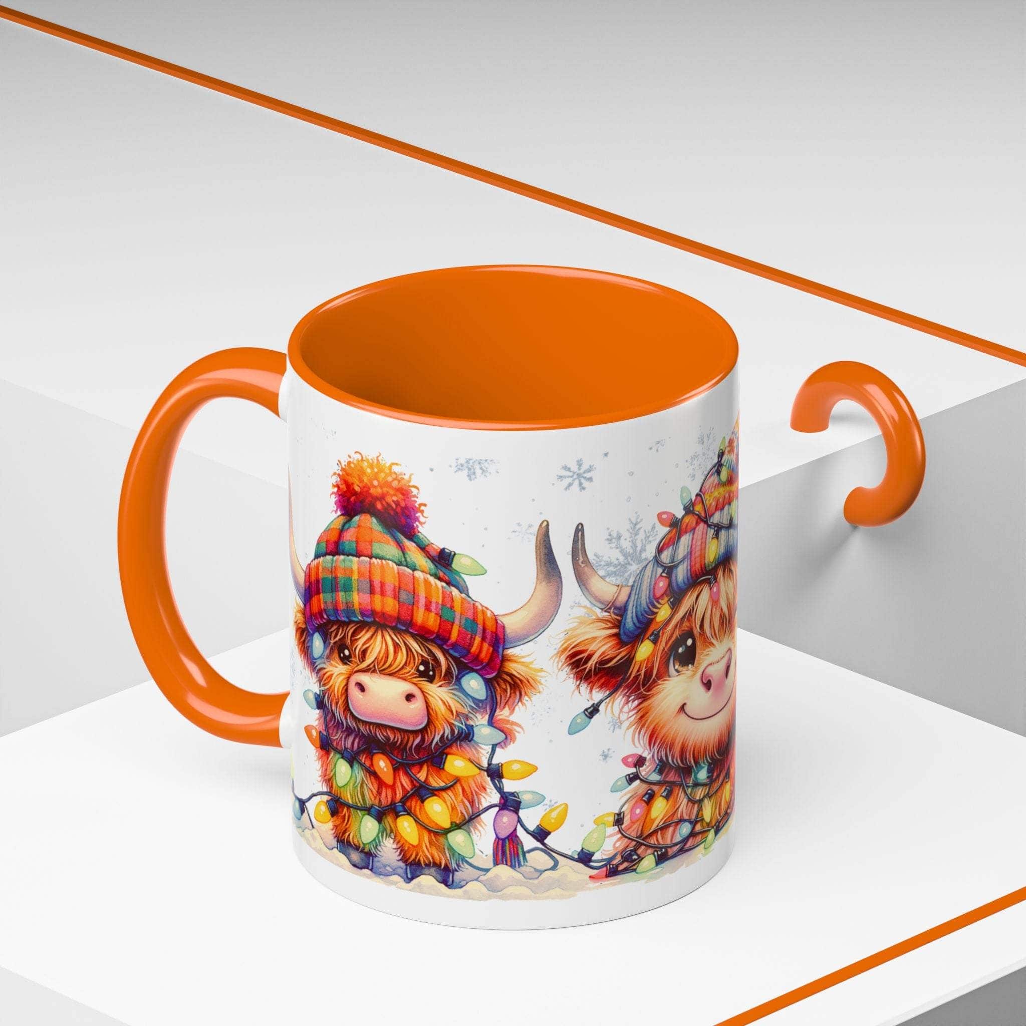 Mug with orange interior and handle featuring Highland cow design on a white background