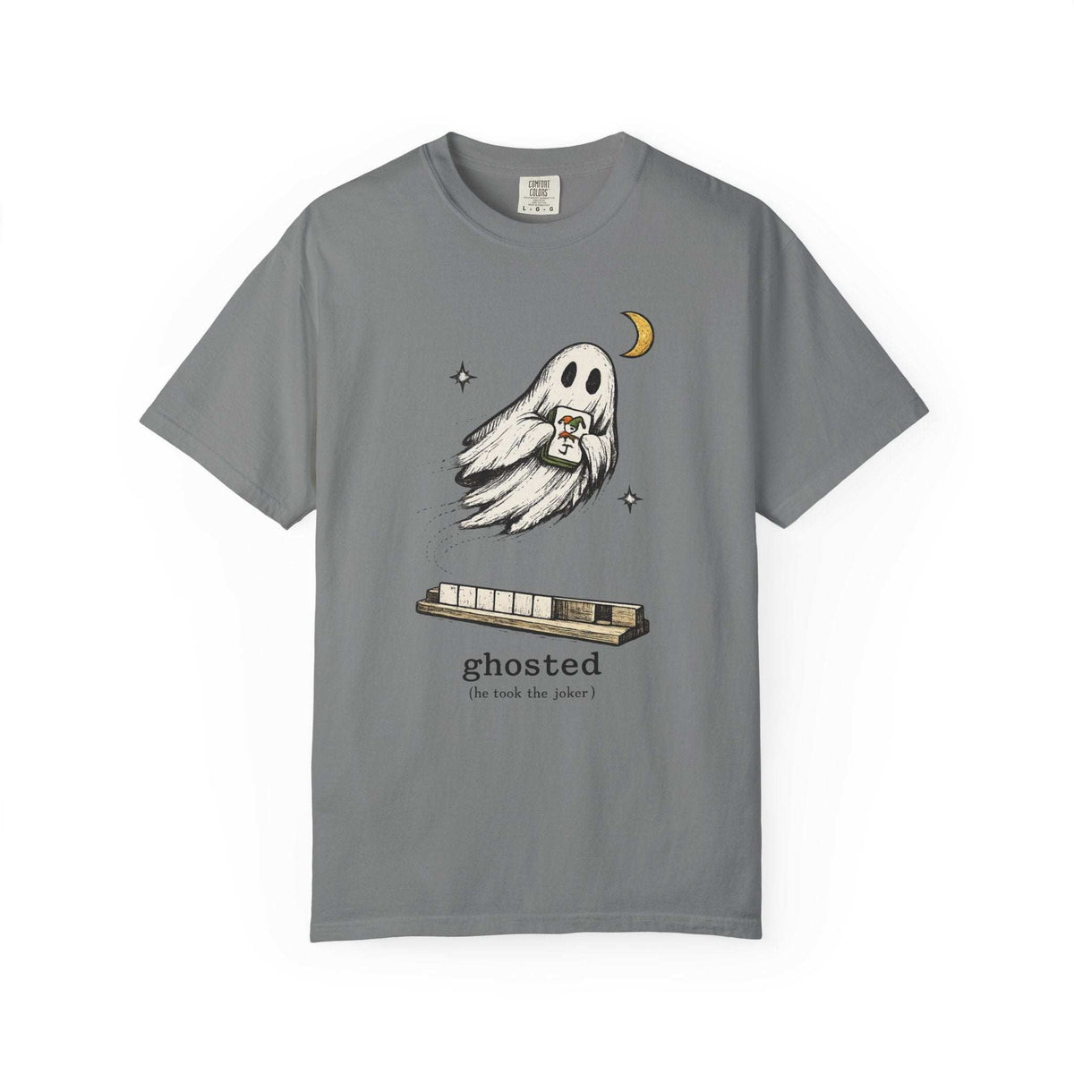 Flat lay of a grey mahjong T-shirt with a ghost holding a joker tile above a tile rack and “ghosted (he took the joker)” lettering.