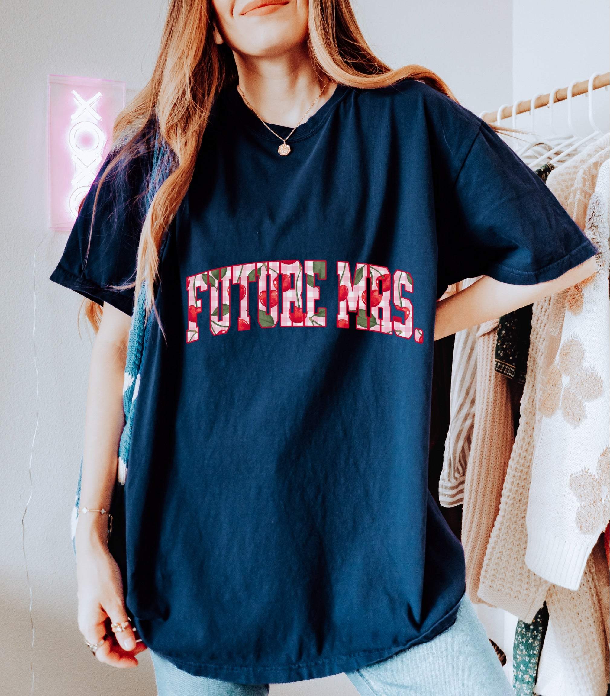 Woman wearing navy blue Future Mrs Cherry t-shirt with floral lettering
