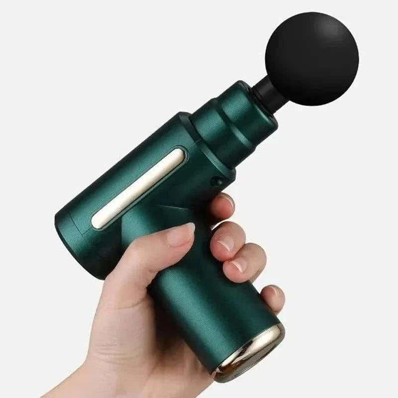 Hand holding green electric muscle relaxation massager gun with round black massage head