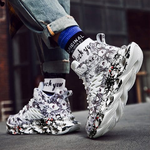 Trendy camouflage sports sneakers with round toe, white and black floral pattern, and thick textured sole for men.