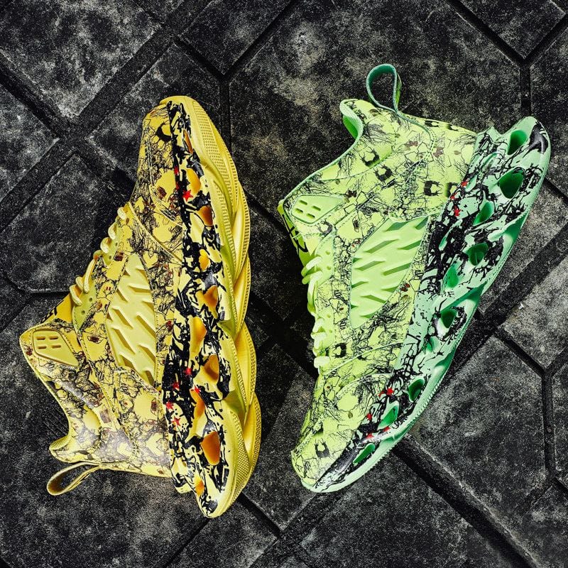 Pair of trendy camouflage sports shoes in yellow and green with round toe, low heel, and flat sole on textured gray pavement background