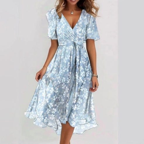 Woman wearing elegant blue chiffon printed short sleeve V-neck dress with floral pattern and mid-length skirt