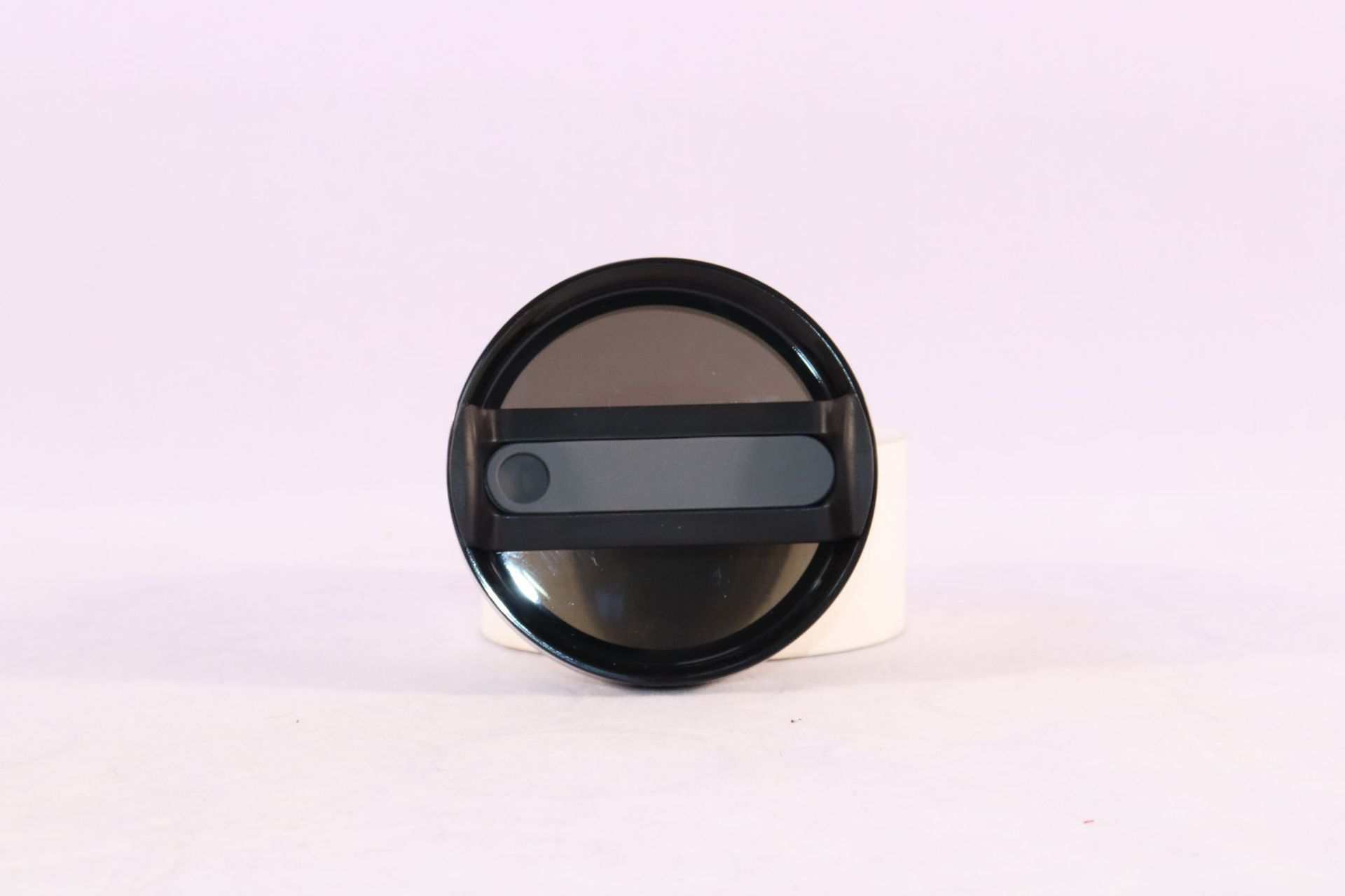 Black spill-proof lid of 40oz insulated stainless steel tumbler with handle and straw.