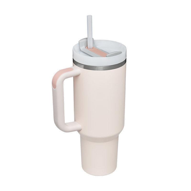 40oz insulated stainless steel tumbler with handle, spill-proof lid, and straw in light pink and white design for hot and cold beverages.