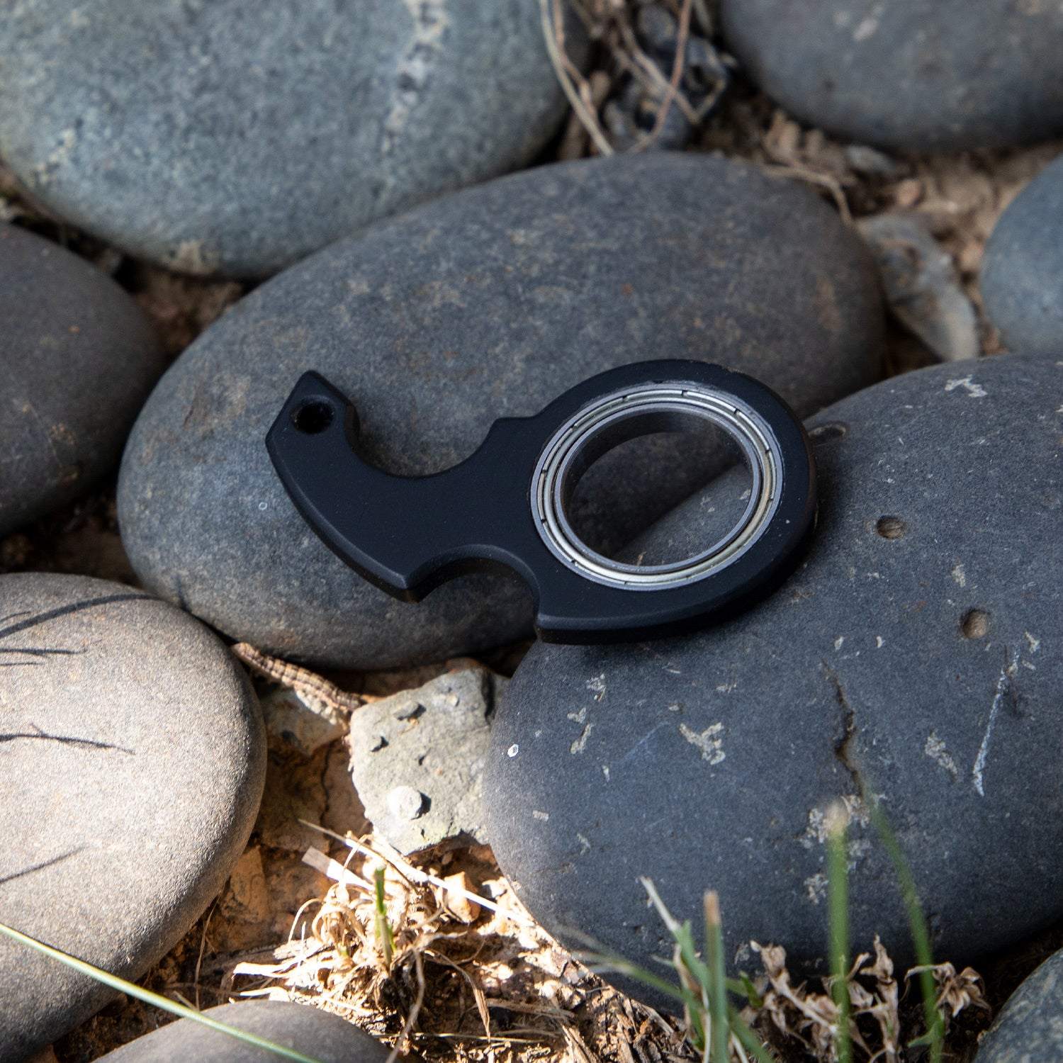 Black keychain fidget spinner toy and bottle opener for stress relief and anxiety.