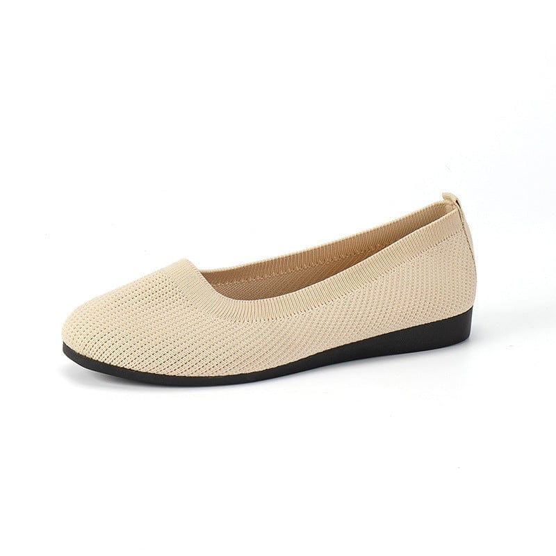 Beige women's round toe flats with soft knit mesh upper and black flat rubber sole, casual comfortable slip-on shoes.