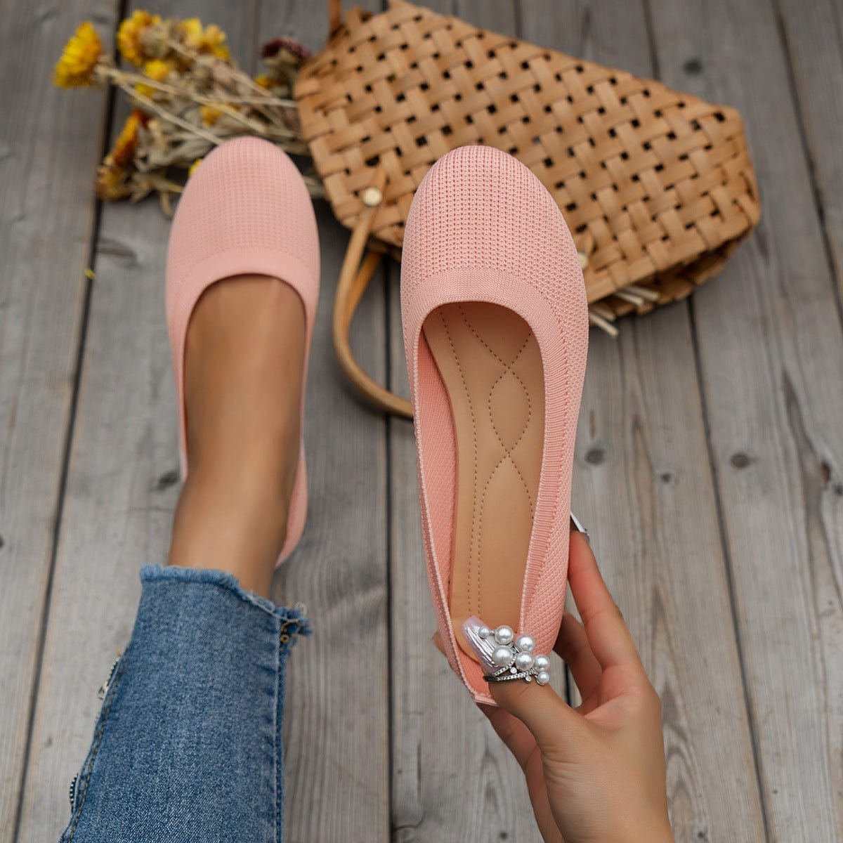 Pink round toe flats shoes for women with knitted mesh material and decorative pearl accessory, casual and comfortable slip-on design.