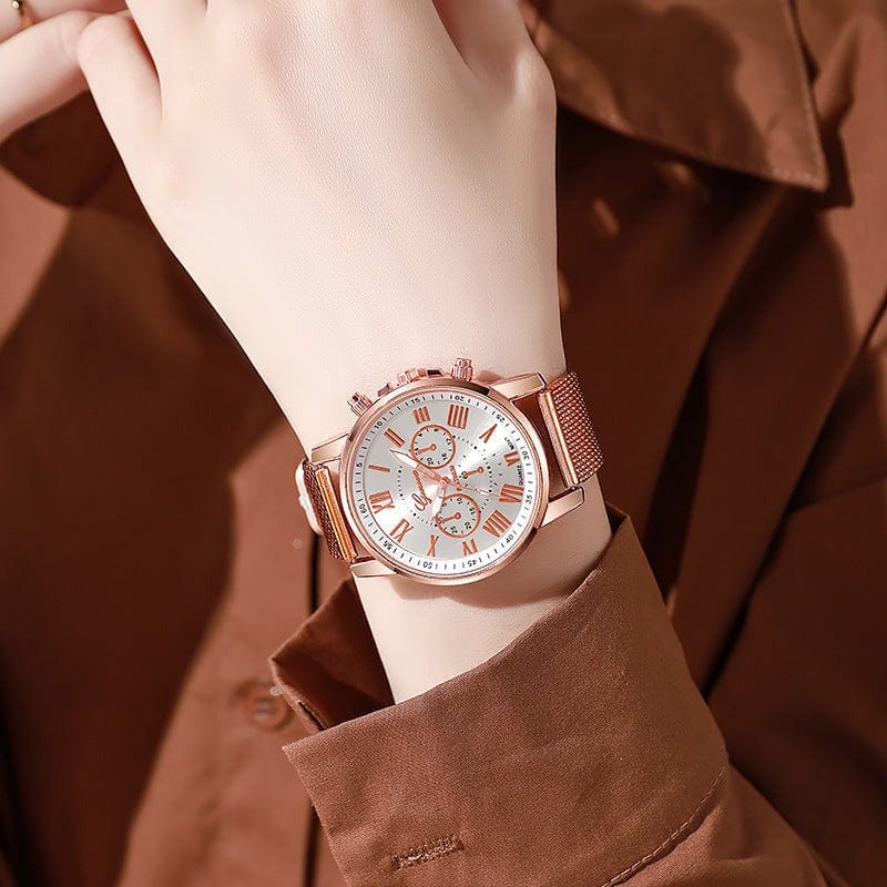 Fashionable women's watch with rose gold mesh band and Roman numeral dial on wrist