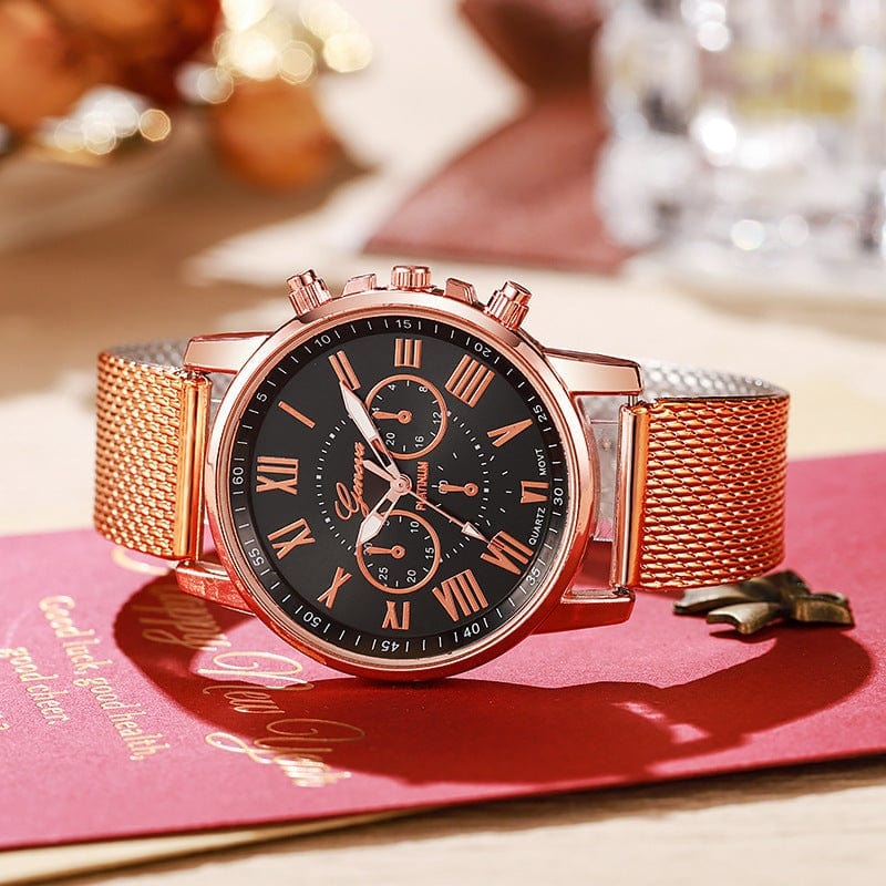 Women's fashion watch with black dial, rose gold Roman numerals, stainless steel mesh band, and spiral crown